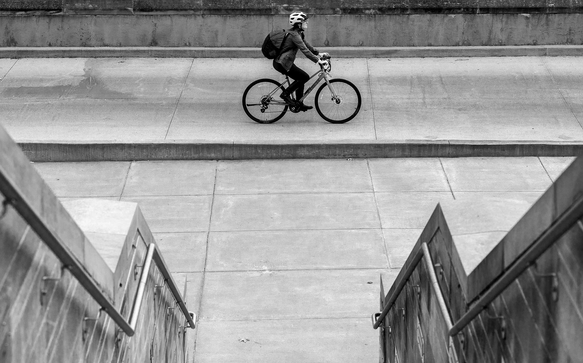 A cyclist crosses campus.