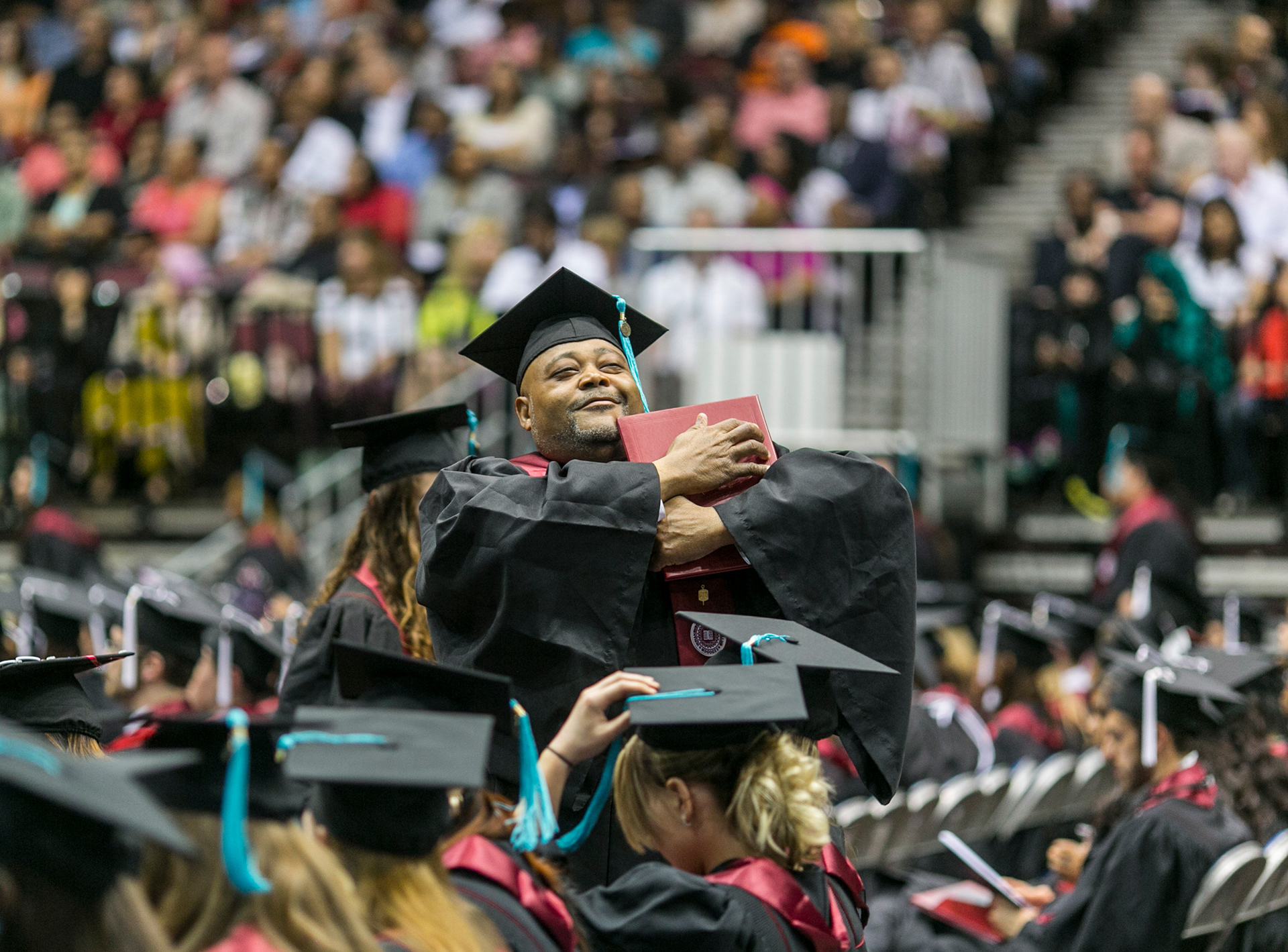 Everett Fitzgerald cradles his diploma cover during IU Northwest's commencement ceremony in Gary.