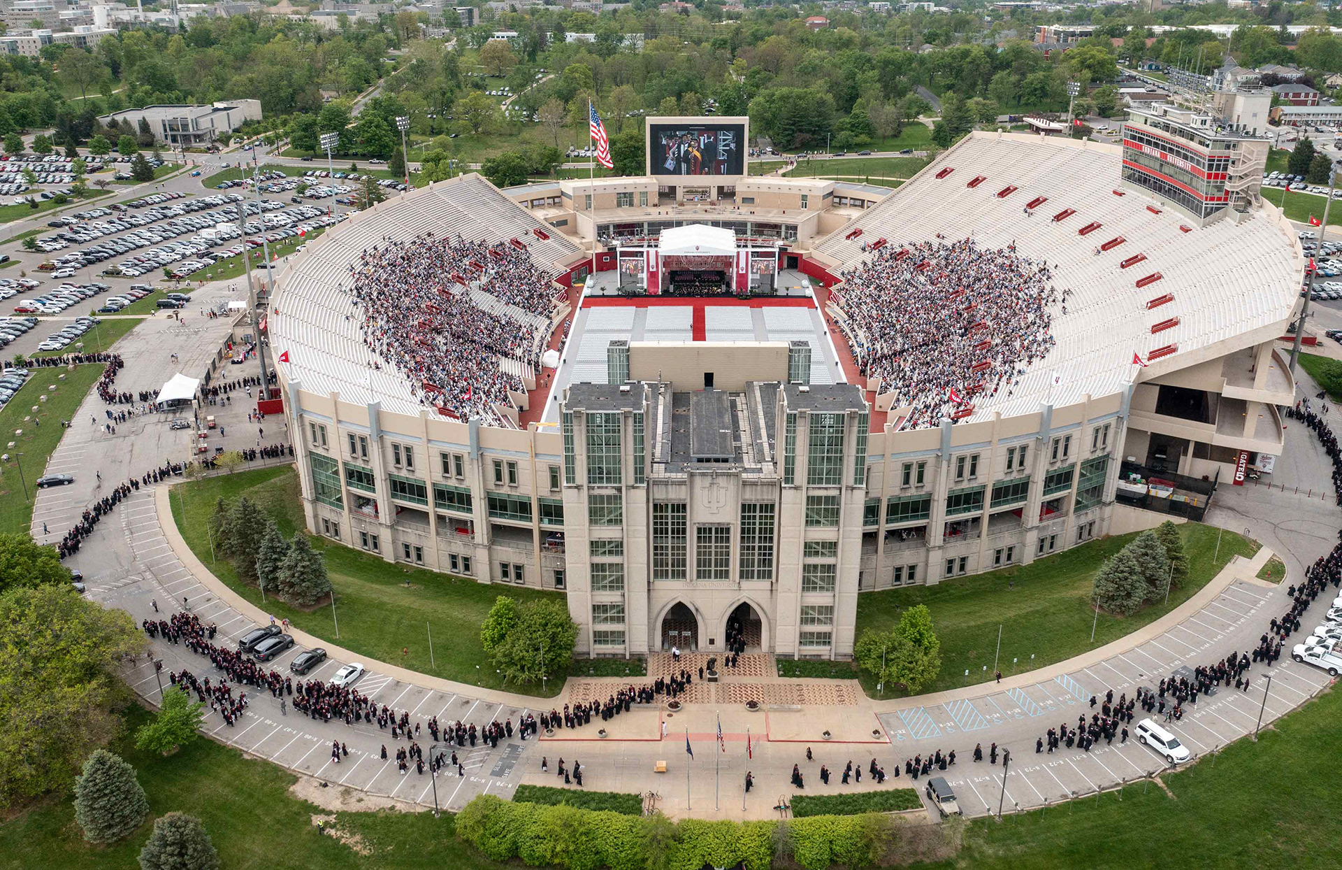 Degree candidates file into Memorial Stadium for graduation.