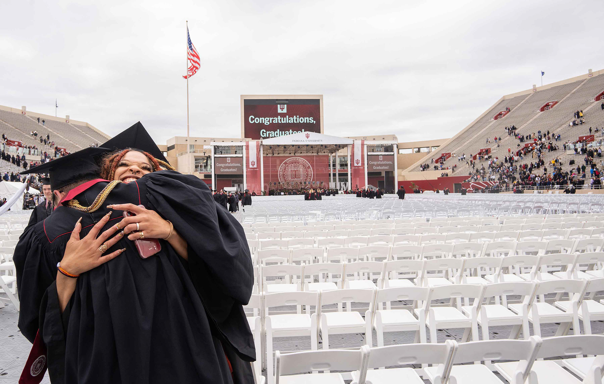 IU grads embrace after commencement.