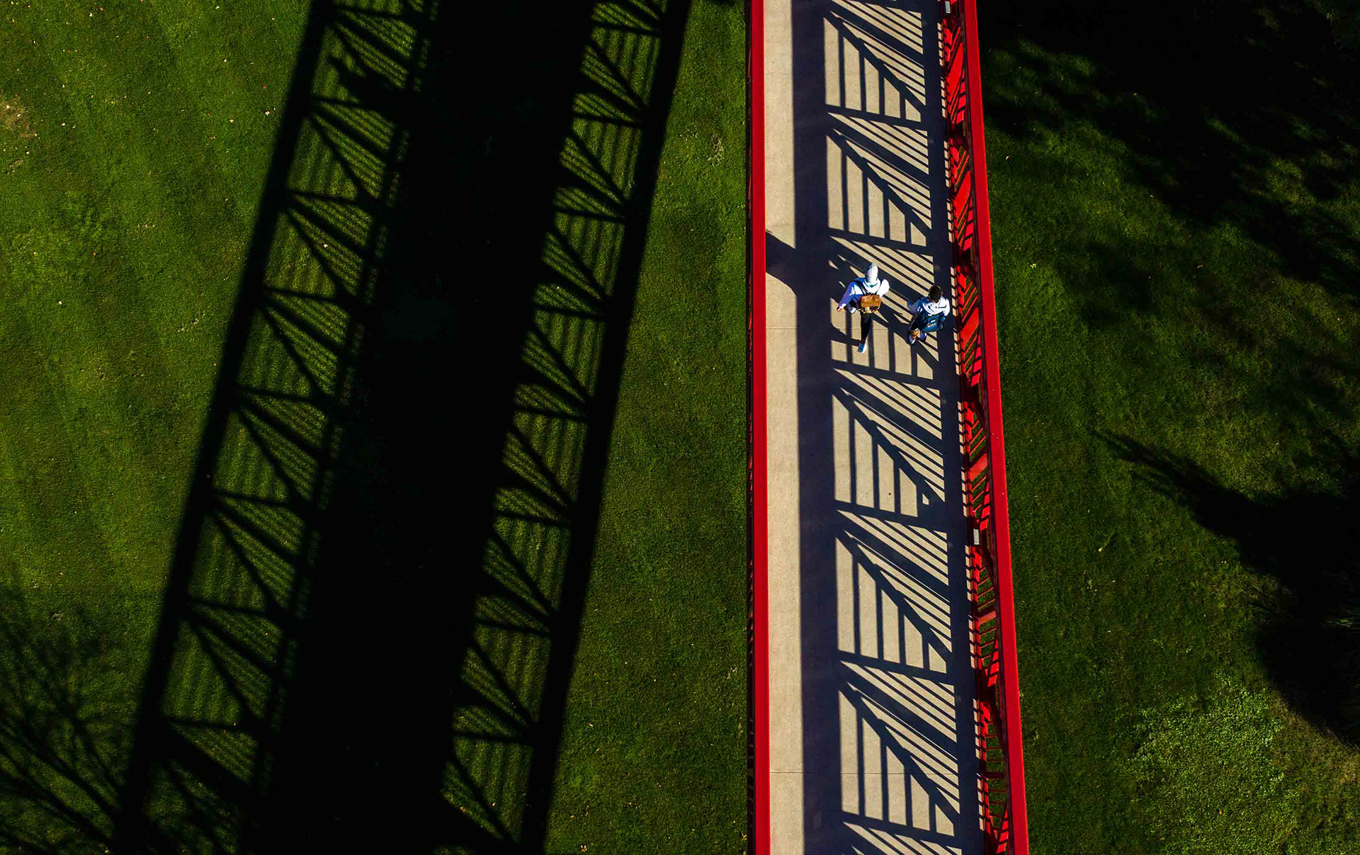 Students walk across a footbridge at IU South Bend.