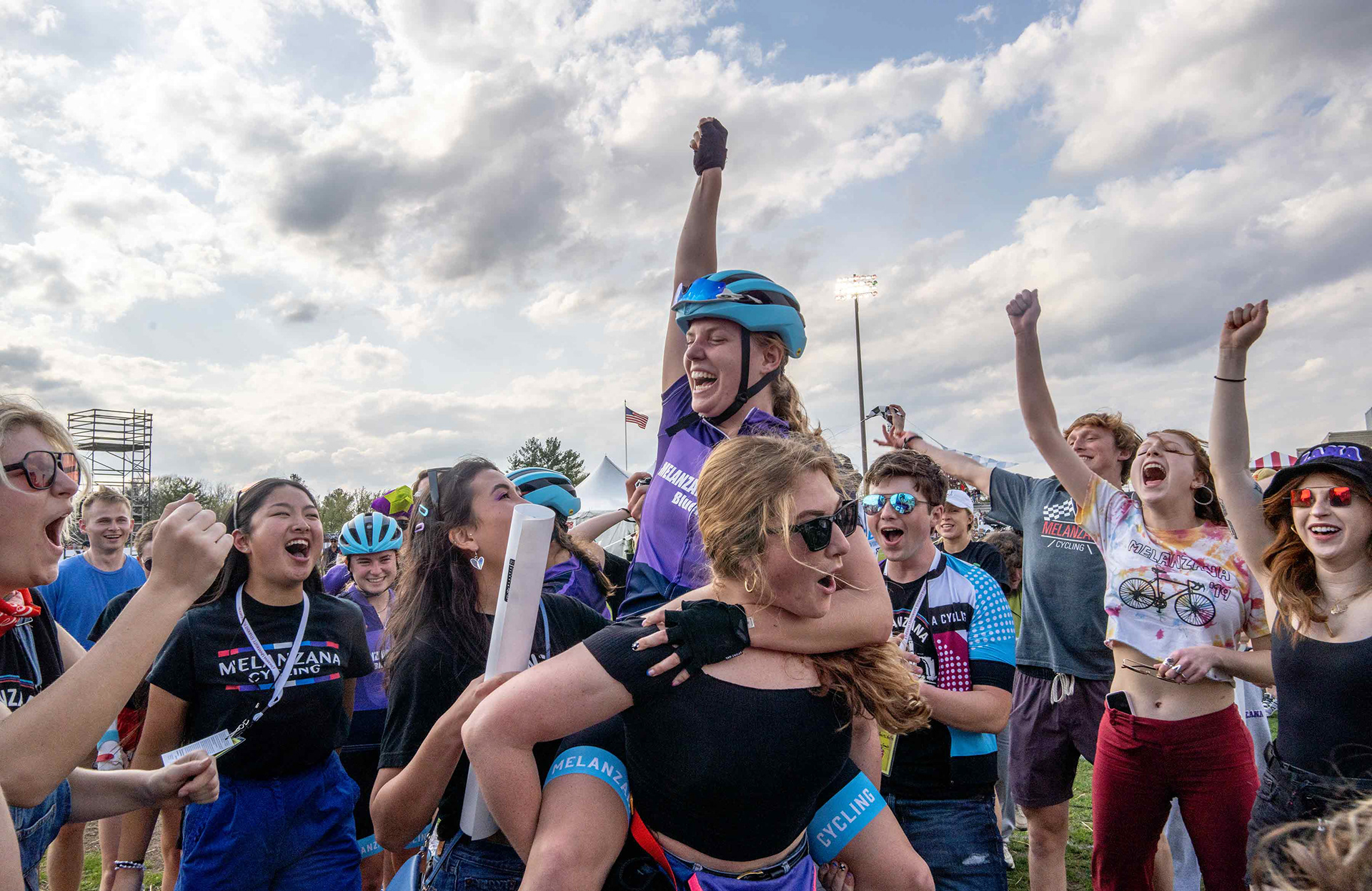 Melanzana Cycling team members and fans celebrate their Little 500 bike race victory.