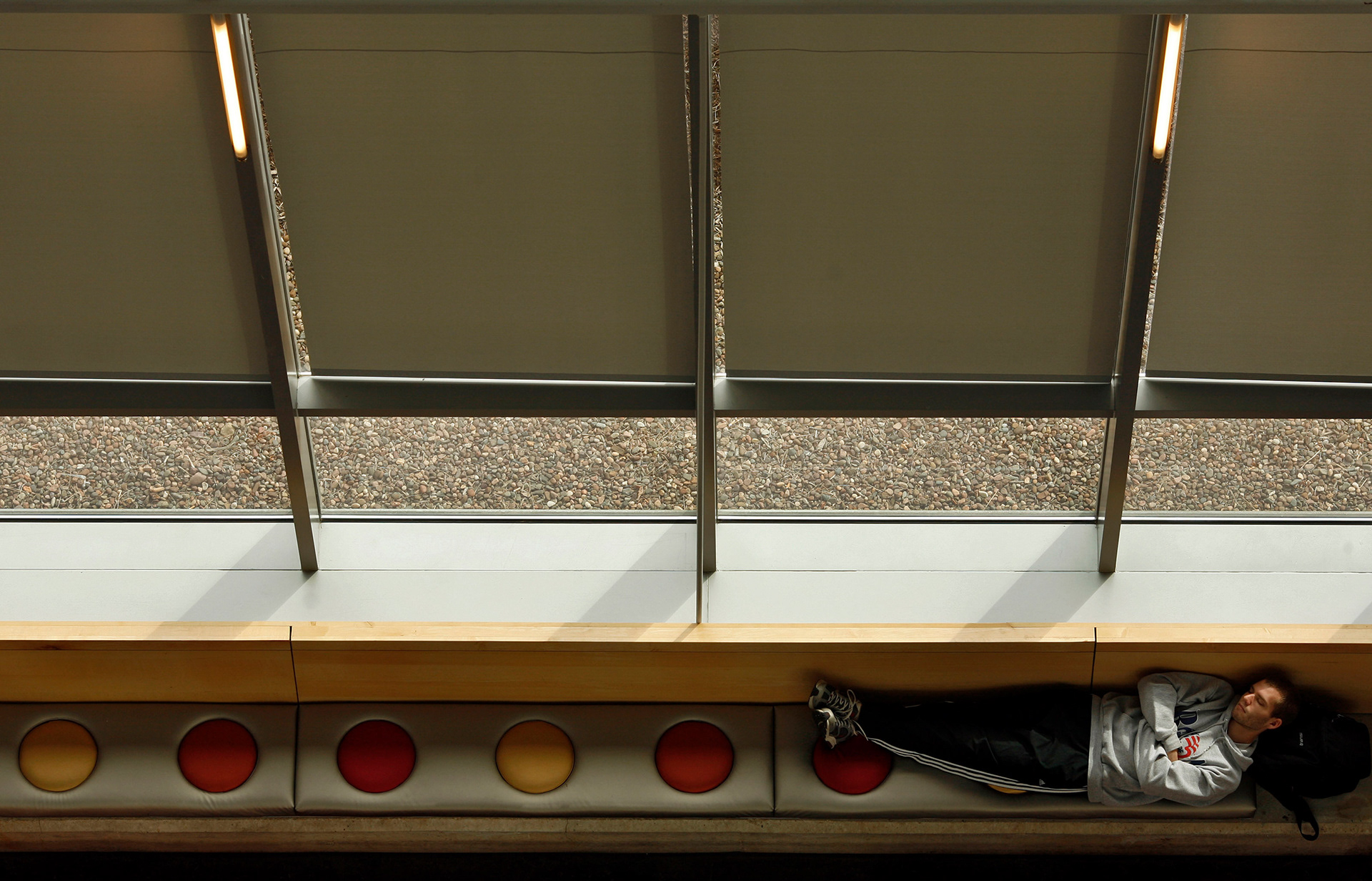 A student takes a nap on the lower level of the IU Indy Campus Center.