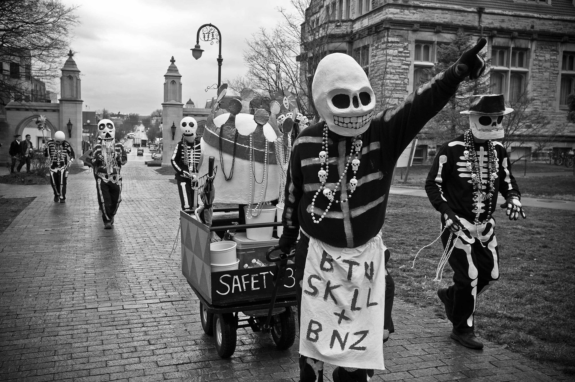 Mardi Gras revelers walk through the IU campus.