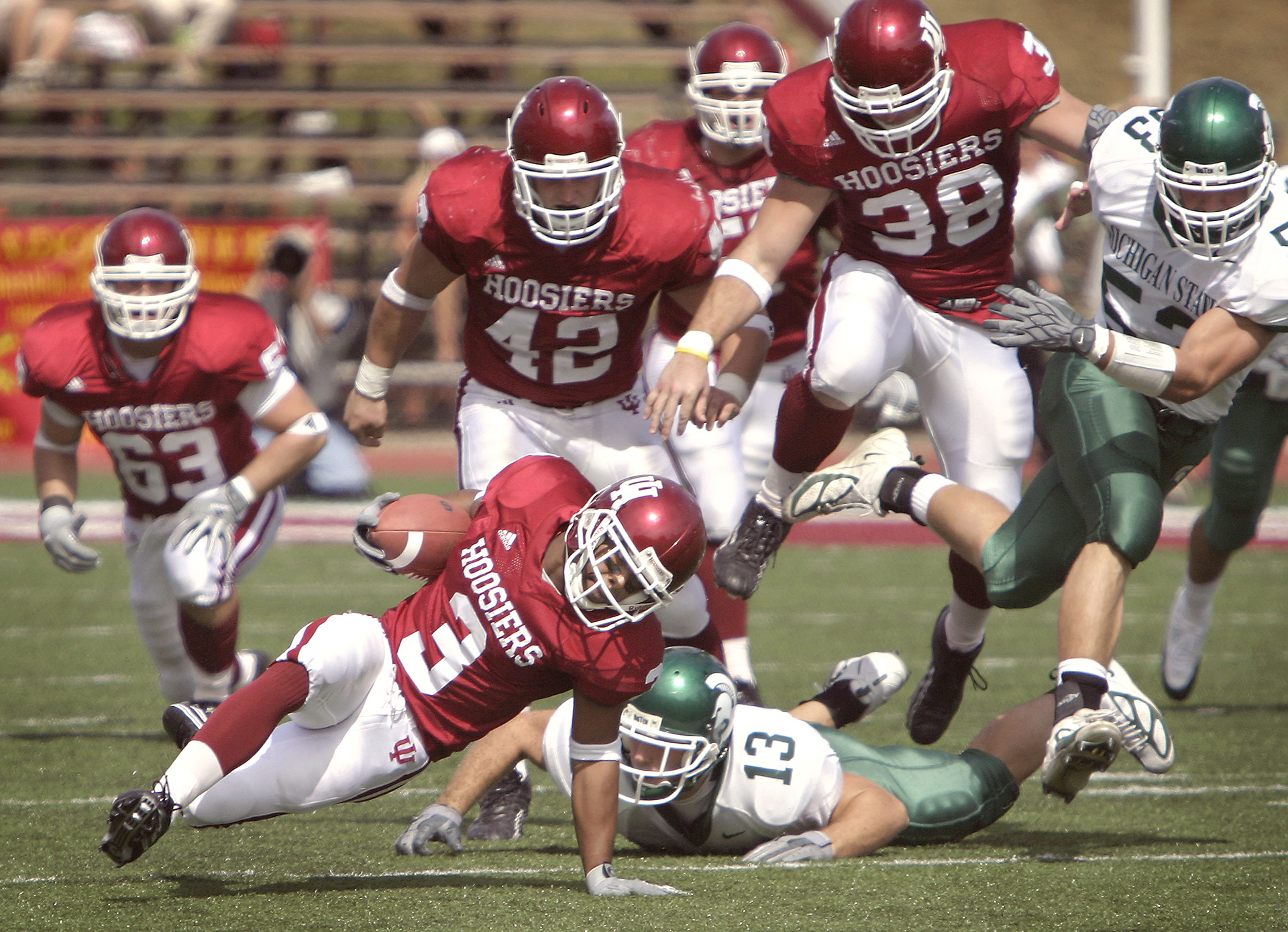 IU running back Lance Bennett (3) struggles to keep his footing as he picks up yardage for the Hoosiers during the game against Michigan State.