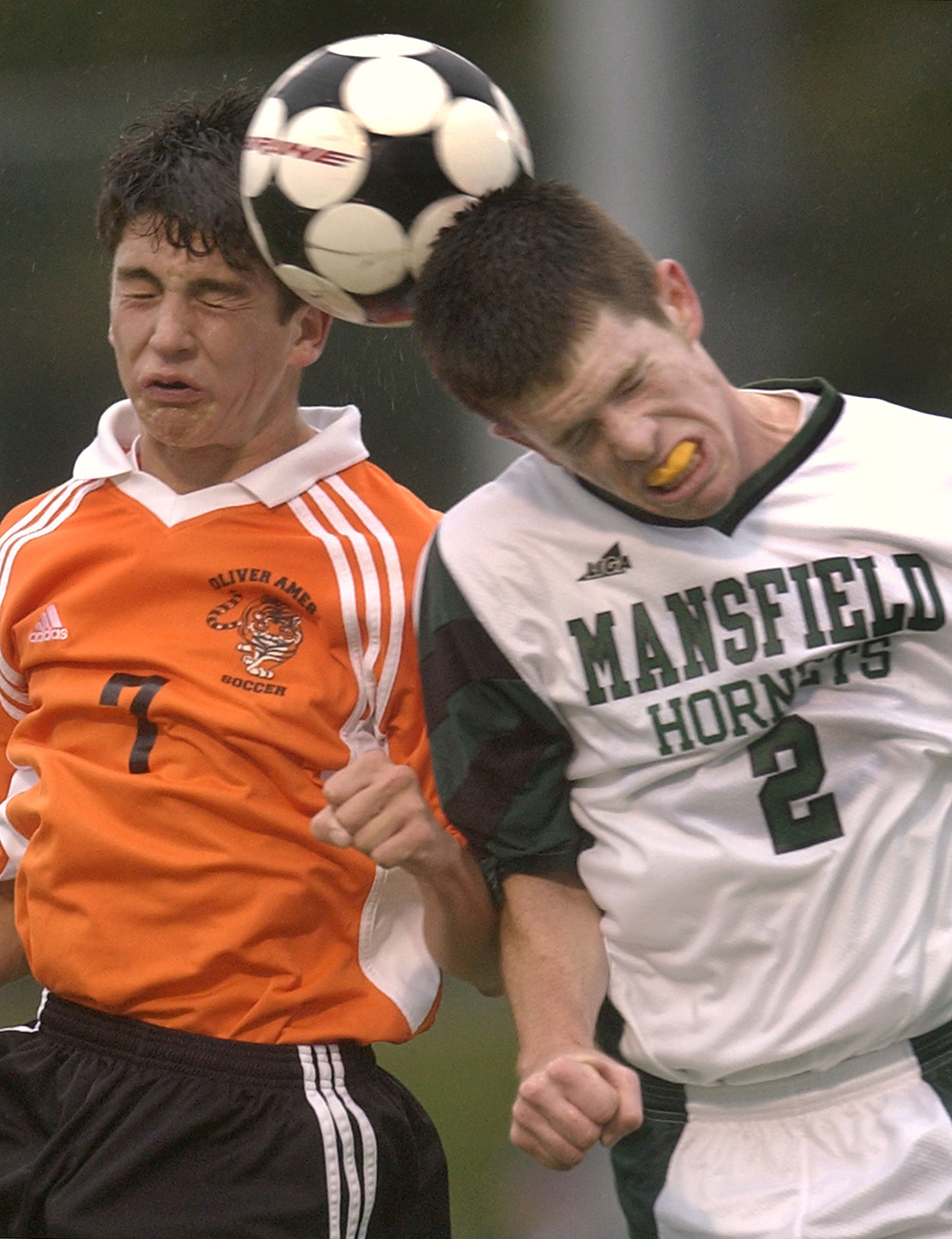 Jesse Carey, left, and Jeremy Langton compete for a header.