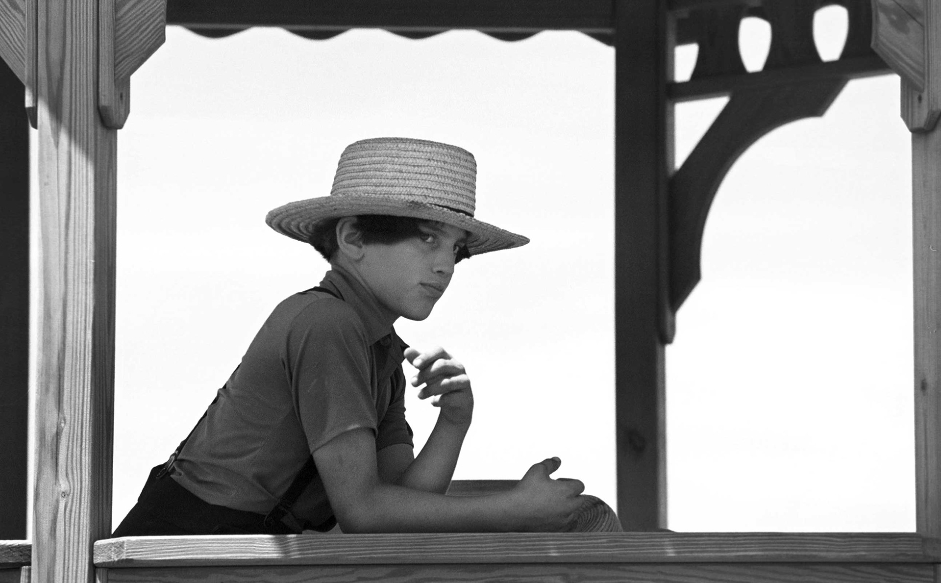 Amish boy framed in a gazebo.