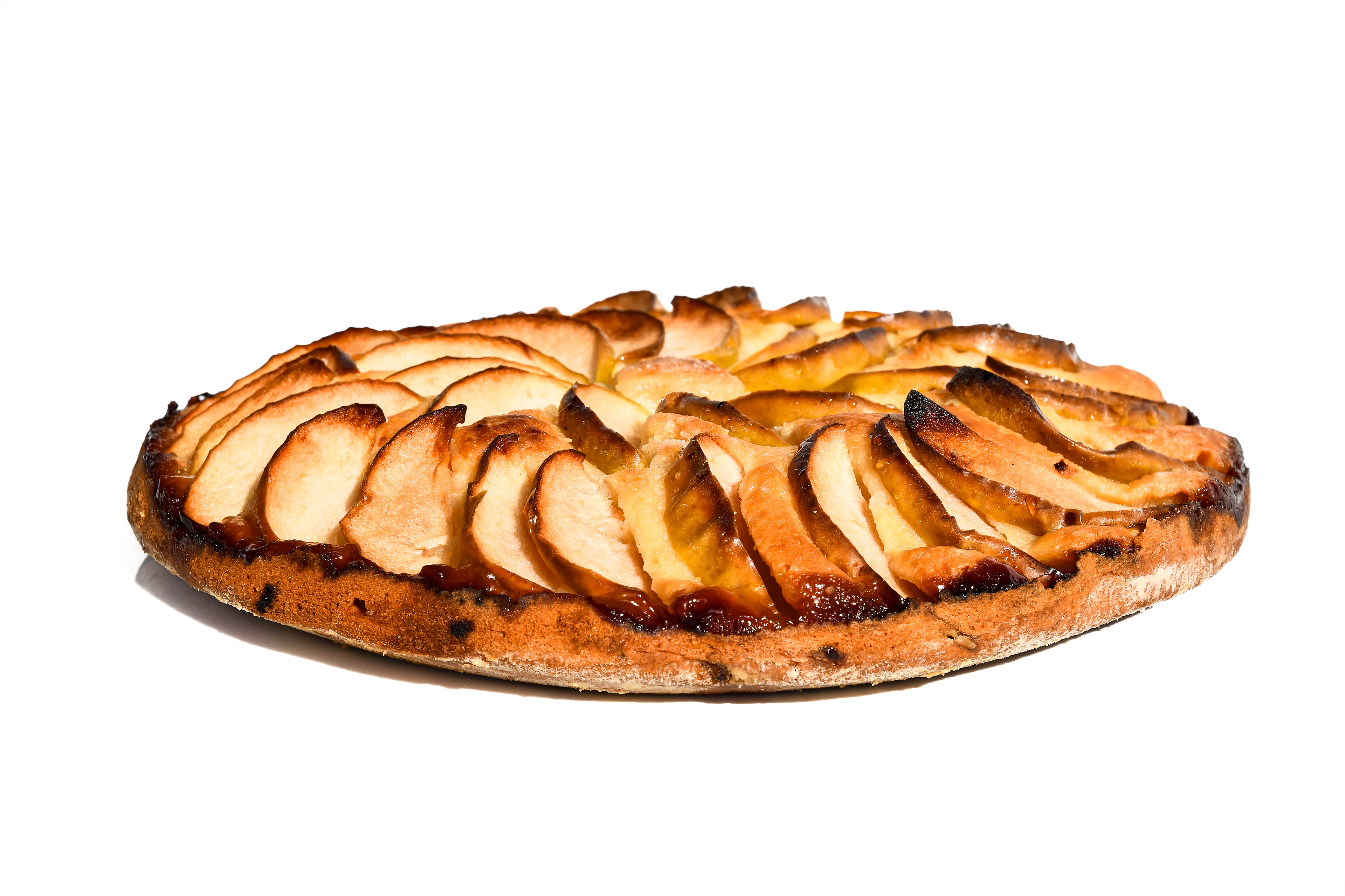 Freshly baked German apple cake (Apfelkuchen) with thin apple slices arranged on top, golden brown and perfectly risen. The cake is moist and fluffy, with a hint of cinnamon. No streusel topping, showcasing the simple, traditional German dessert.