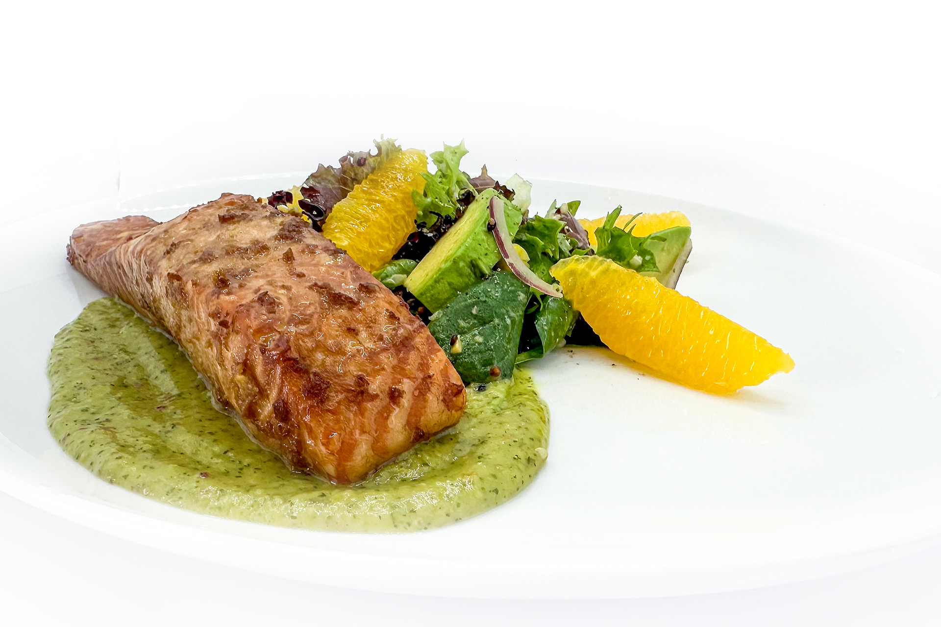 Cedar Planked Salmon on Quinoa Avocado Salad: A gourmet dish featuring a piece of cedar-planked salmon served with a fresh quinoa avocado salad, garnished with orange segments and a drizzle of green herb sauce, beautifully arranged on a white plate.