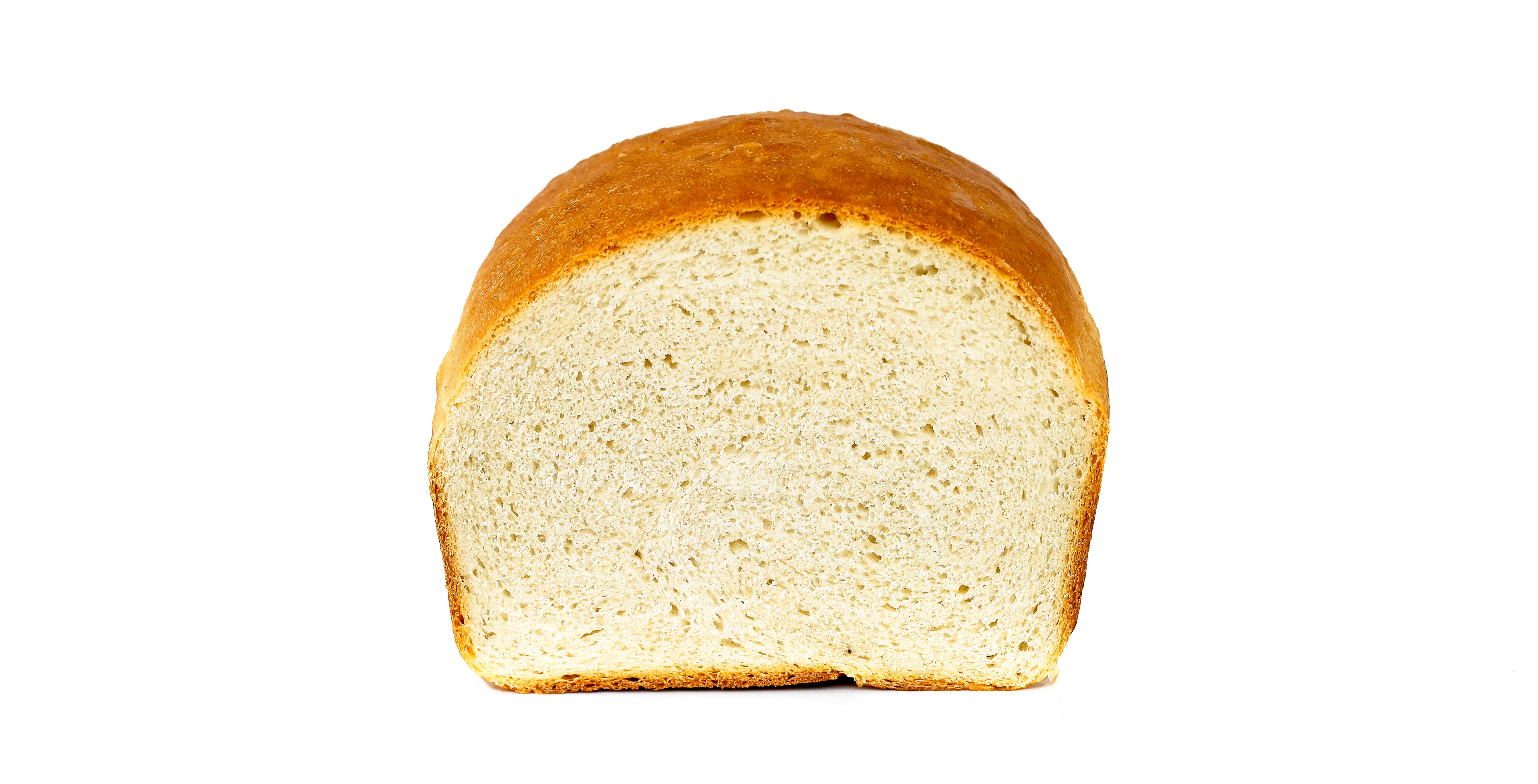 "Freshly baked sandwich bread on a cooling rack, golden and fluffy inside.