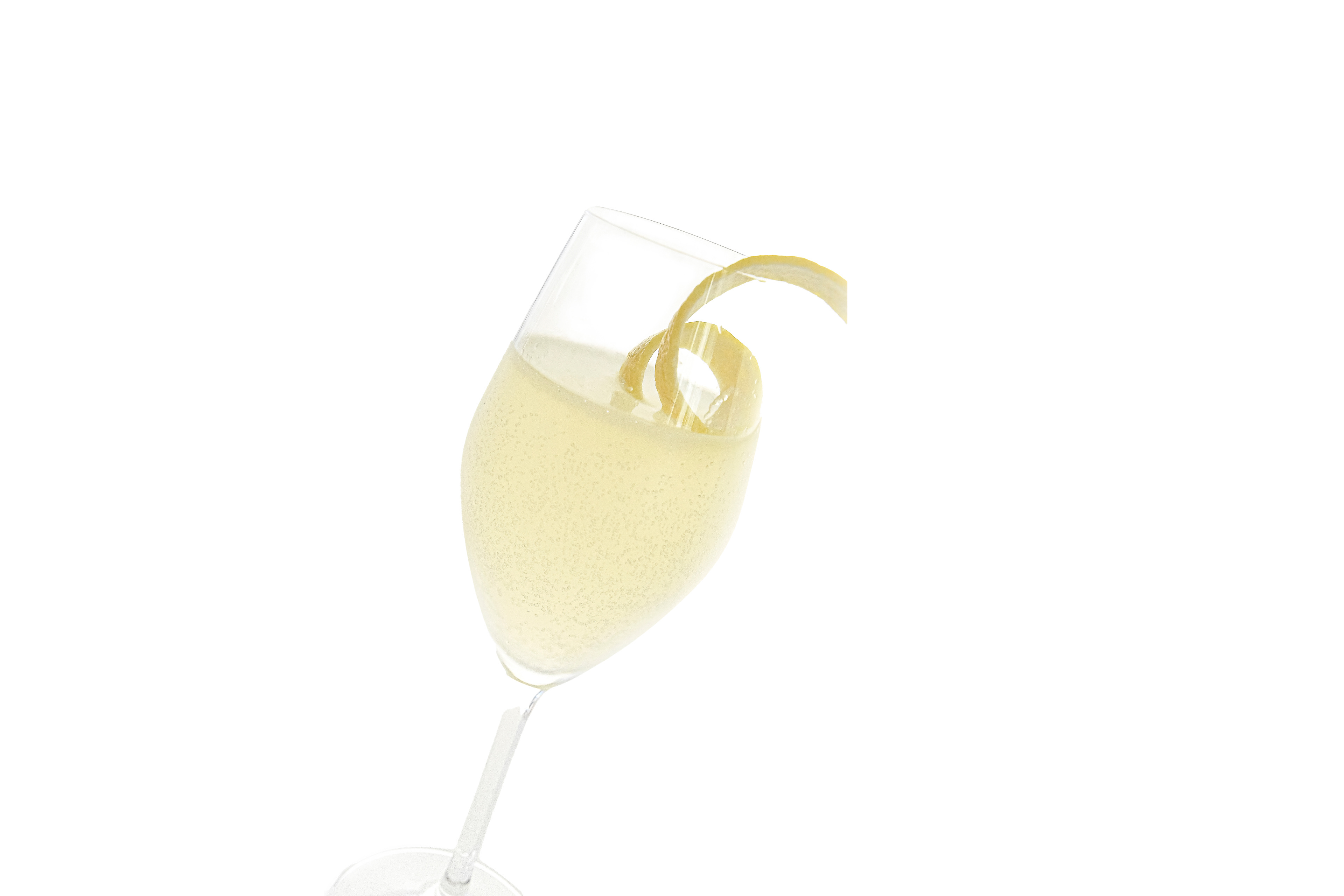 A classic French 75 cocktail elegantly displayed in a tall champagne flute. The drink features a pale golden hue with a delicate lemon twist resting on the rim. The pristine white background highlights the simplicity and sophistication of the cocktail, making it the centerpiece of the image