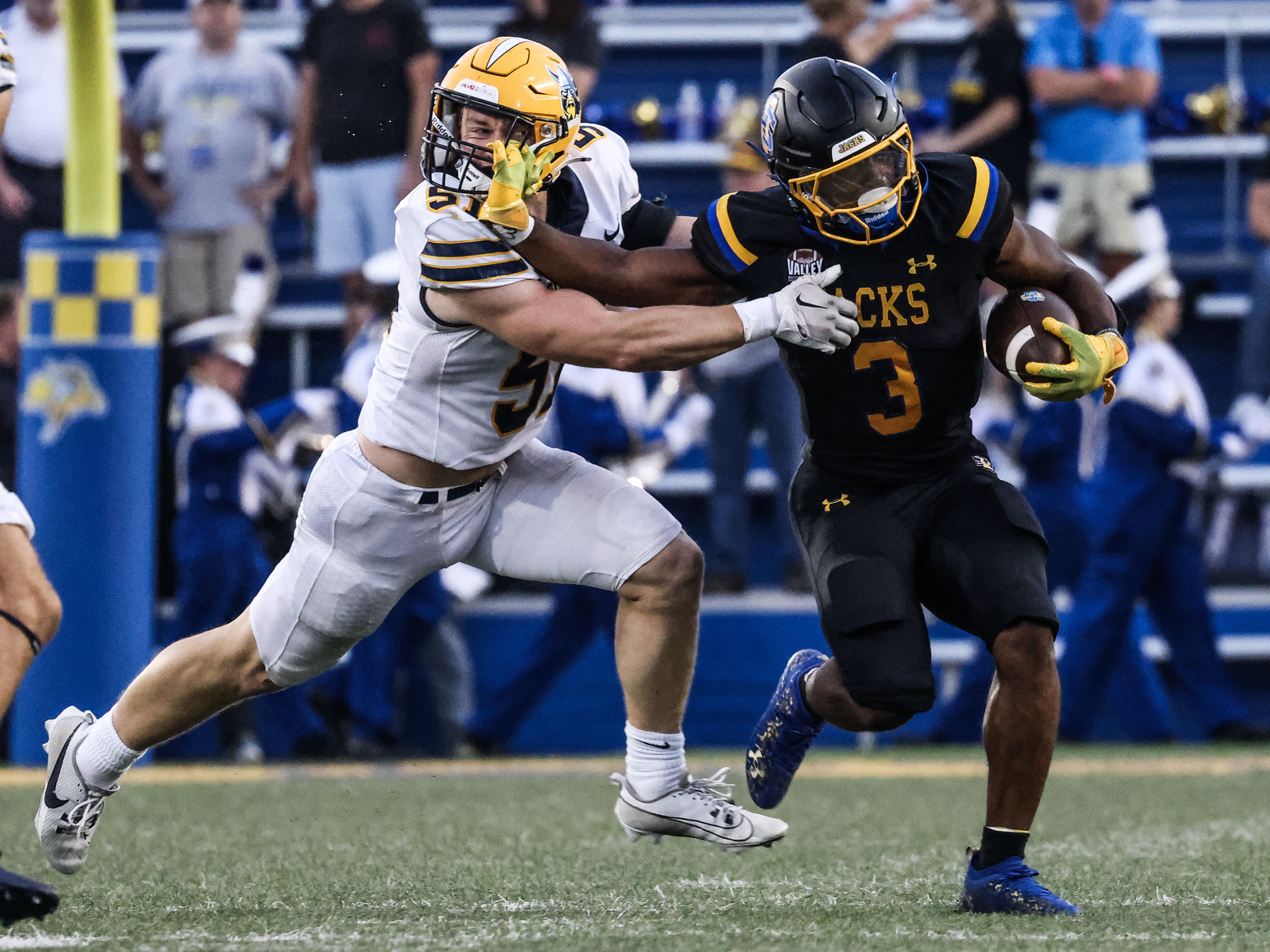South Dakota State’s Amar Johnson fends off an Augustana defender with a stiff-arm during the annual Beef Bowl in Brookings.