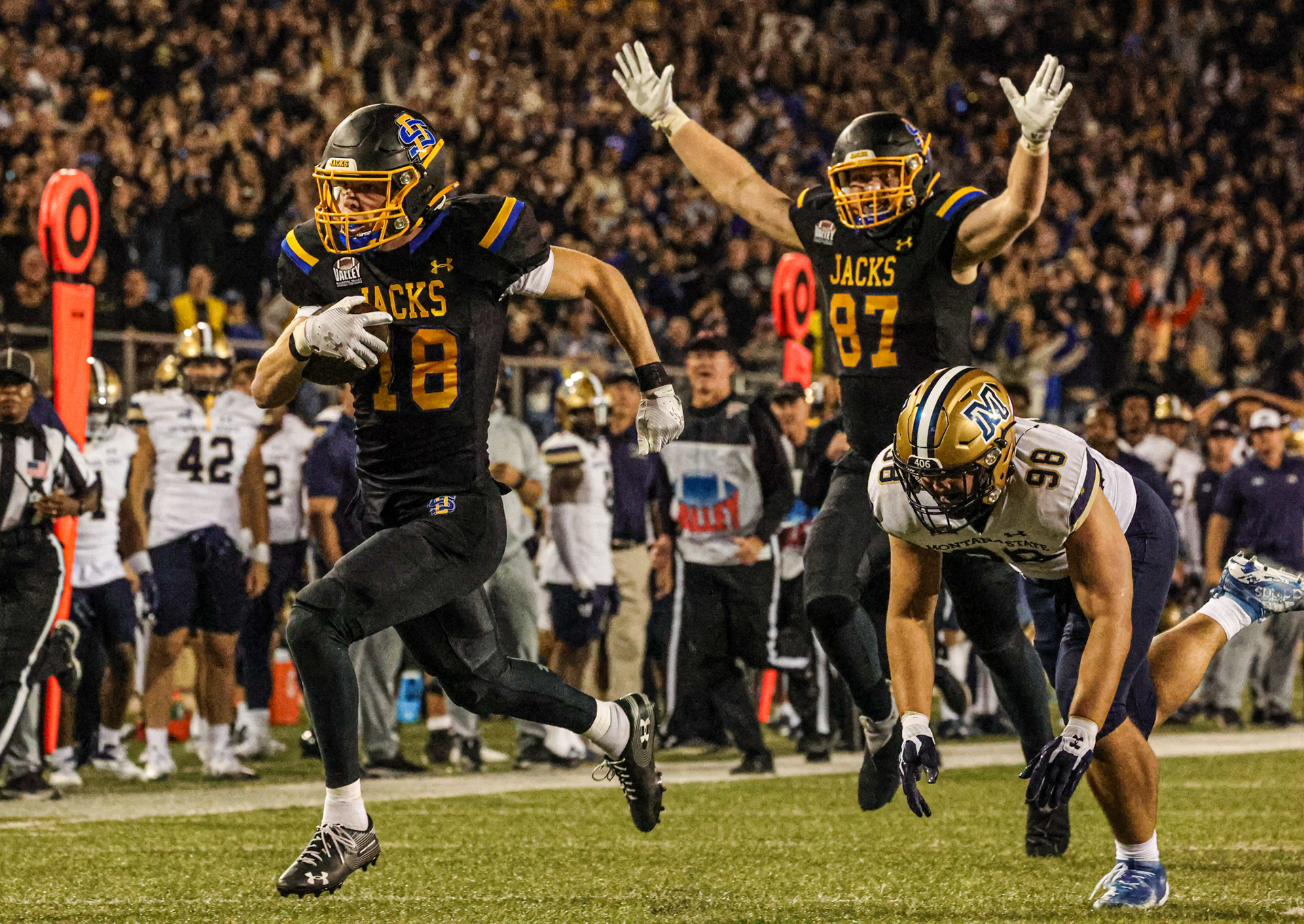 South Dakota State’s Griffin Wilde sprints into the end zone for a go-ahead touchdown late in the fourth quarter against No. 3 Montana State. Tight end Zach Heins throws his arms up in celebration behind him as the Jackrabbits seize control in the top-ranked showdown.