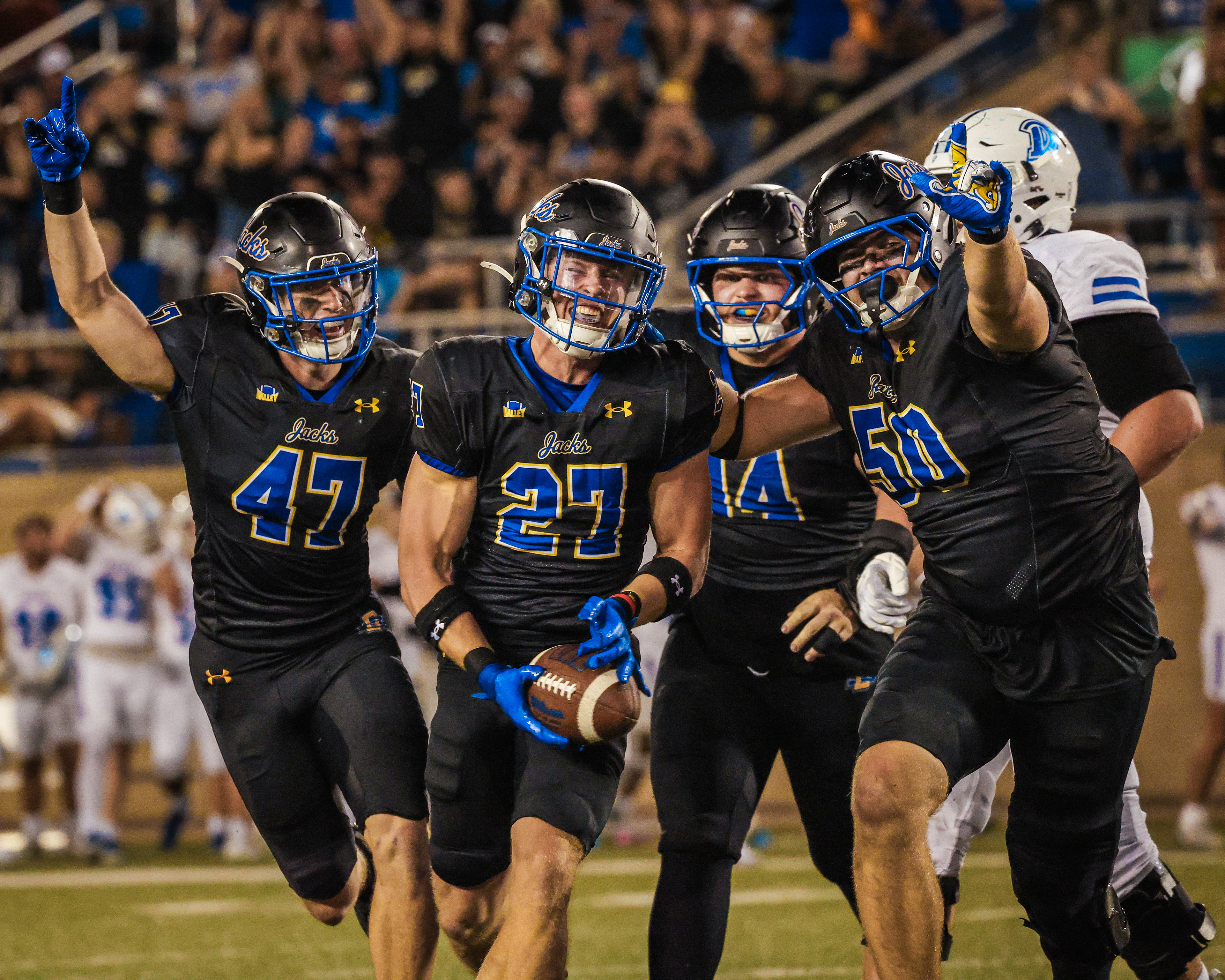 South Dakota State’s Noah Thompson celebrates with teammates after recording his first career interception against Drake.