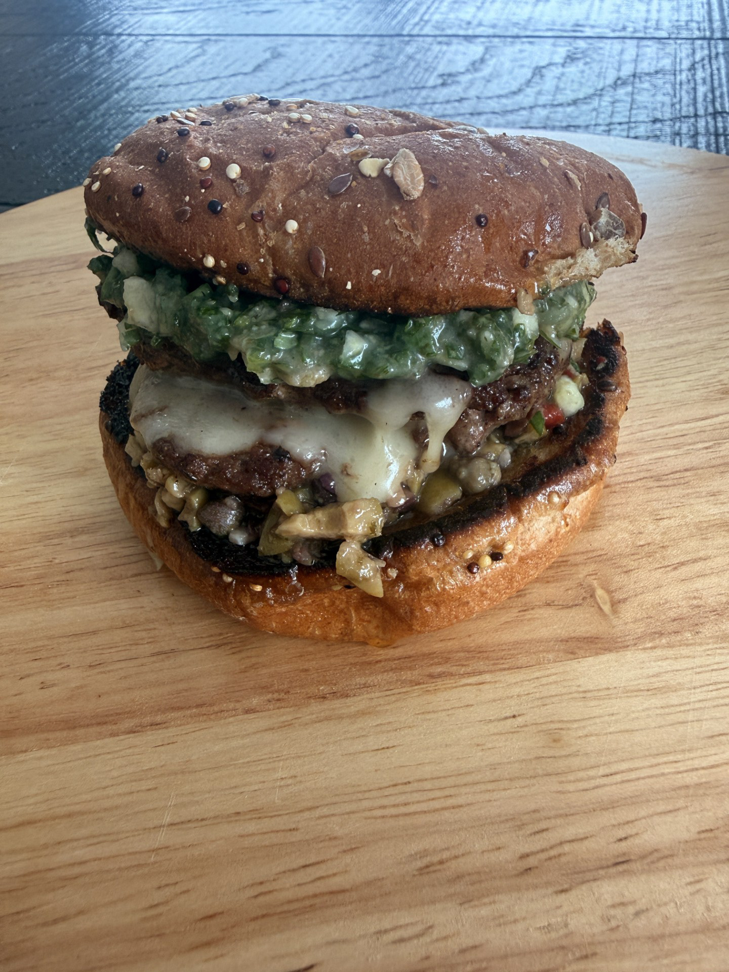 Buenos Aires Burger - Glacial Lakes Distillery featuring,  Black Sheep Food Truck - A two smash patty Argentinian style burger with a bone marrow chimichurri sauce and olive oil spread with a creamy brie sauce. Served in a whole wheat bun and a side of Waldorf salad.