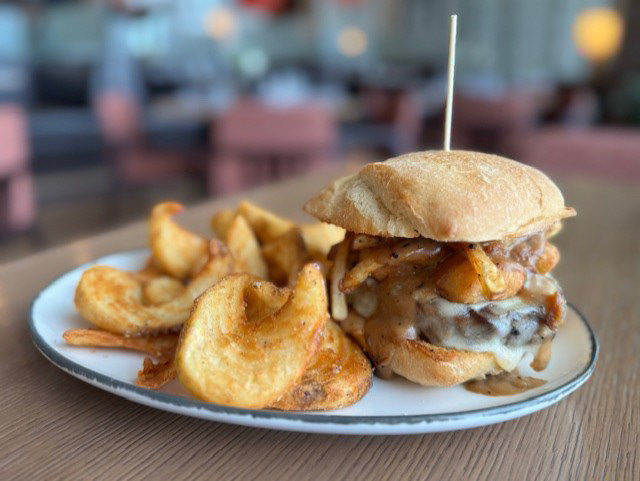 The Canadian Express - Cascata - 1/2lb Demkota Ranch Beef burger patty with fresh mozzarella, hand cut fries, cheese curds, brown gravy and chopped bacon all presented on a locally sourced Ciabatta bun, served with a side of truffle parm sidewinder fries.