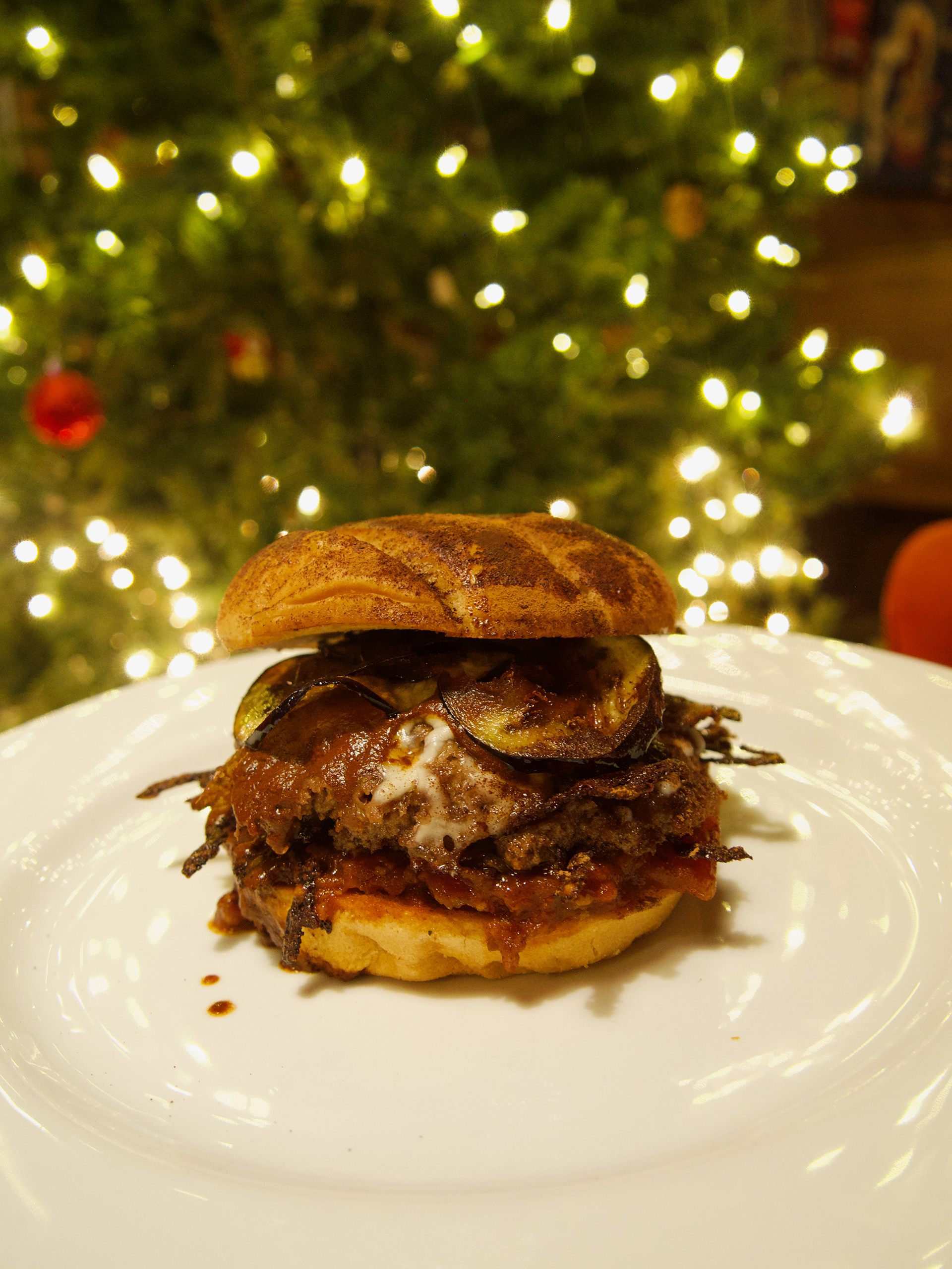 The Shaggy - DaDa -  Potato bun dusted in sweetened cocoa powder, tomato jam, eggplant chips, havarti cheese and housemade chocolate hot sauce.