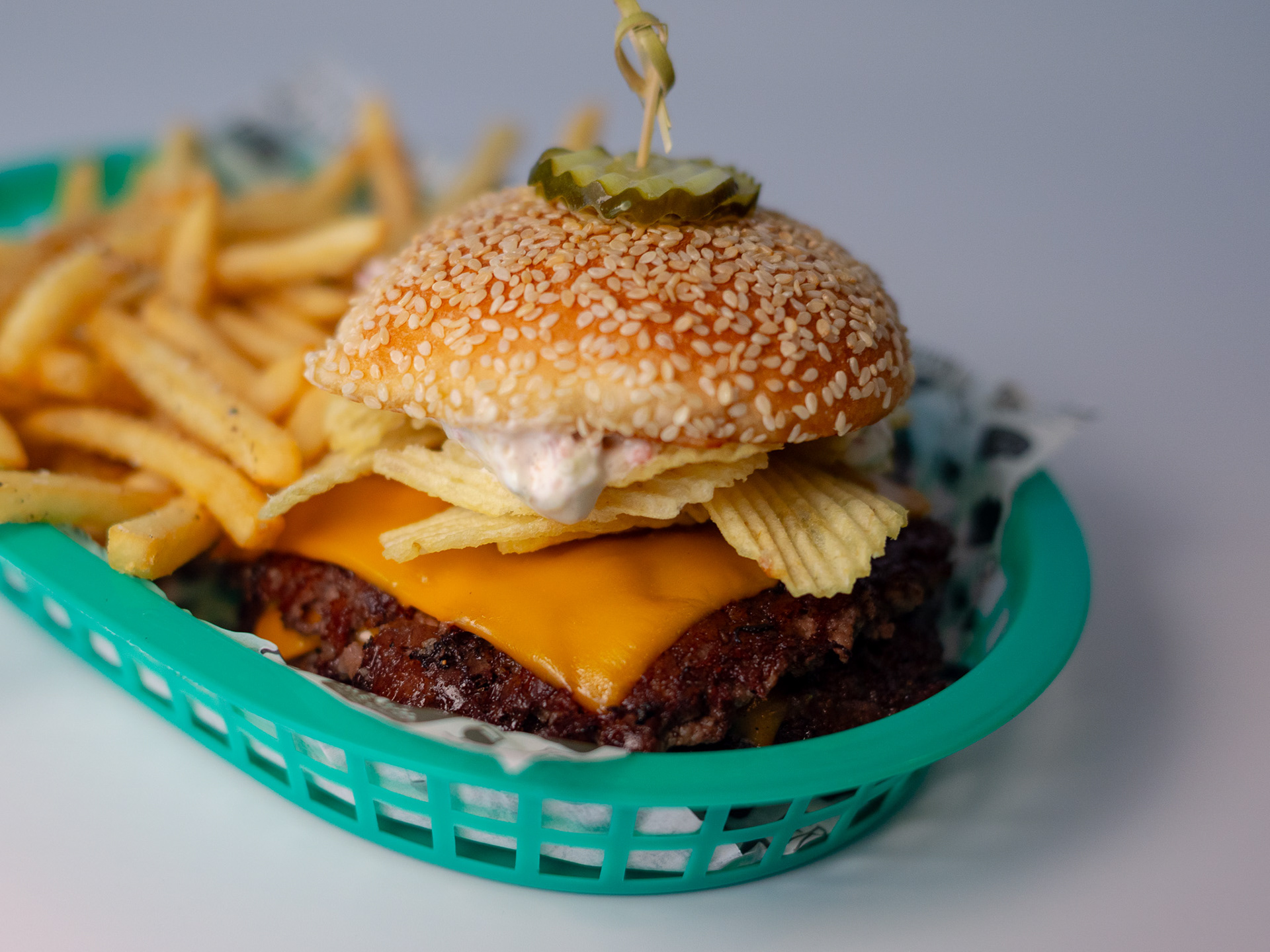 The Pickle Roll Burger - Fernson Downtown & Totally Rad Eats - Double smash patty, new school American cheese, dried beef pickle roll dip, pickles, ruffles, on a big Marty roll. Served with fries or tots.