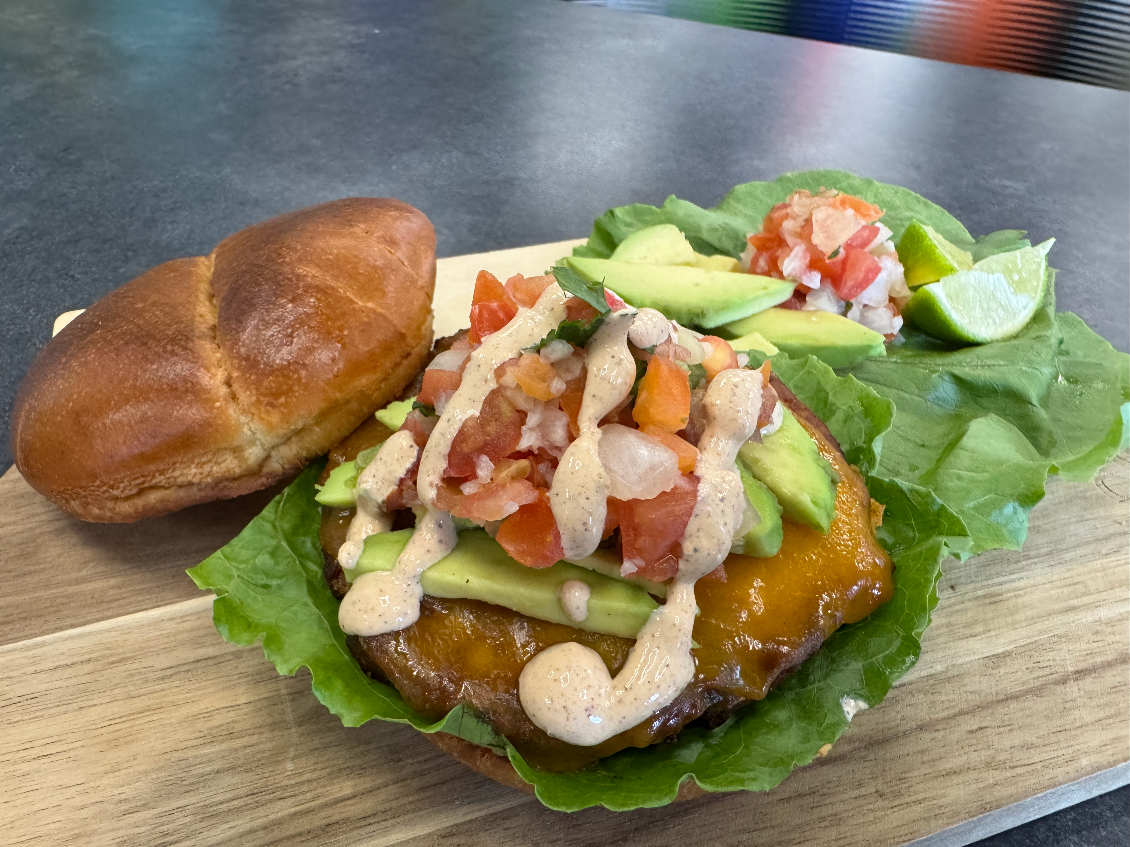 Mexican Black Bean Burger - The WP - The WP Cafe will be serving a spicy black bean and corn burger on a toasted brioche bun, dressed with chili-lime seasoned sour cream, with melted cheddar, lettuce, avocado, and jalapeno pico de gallo.