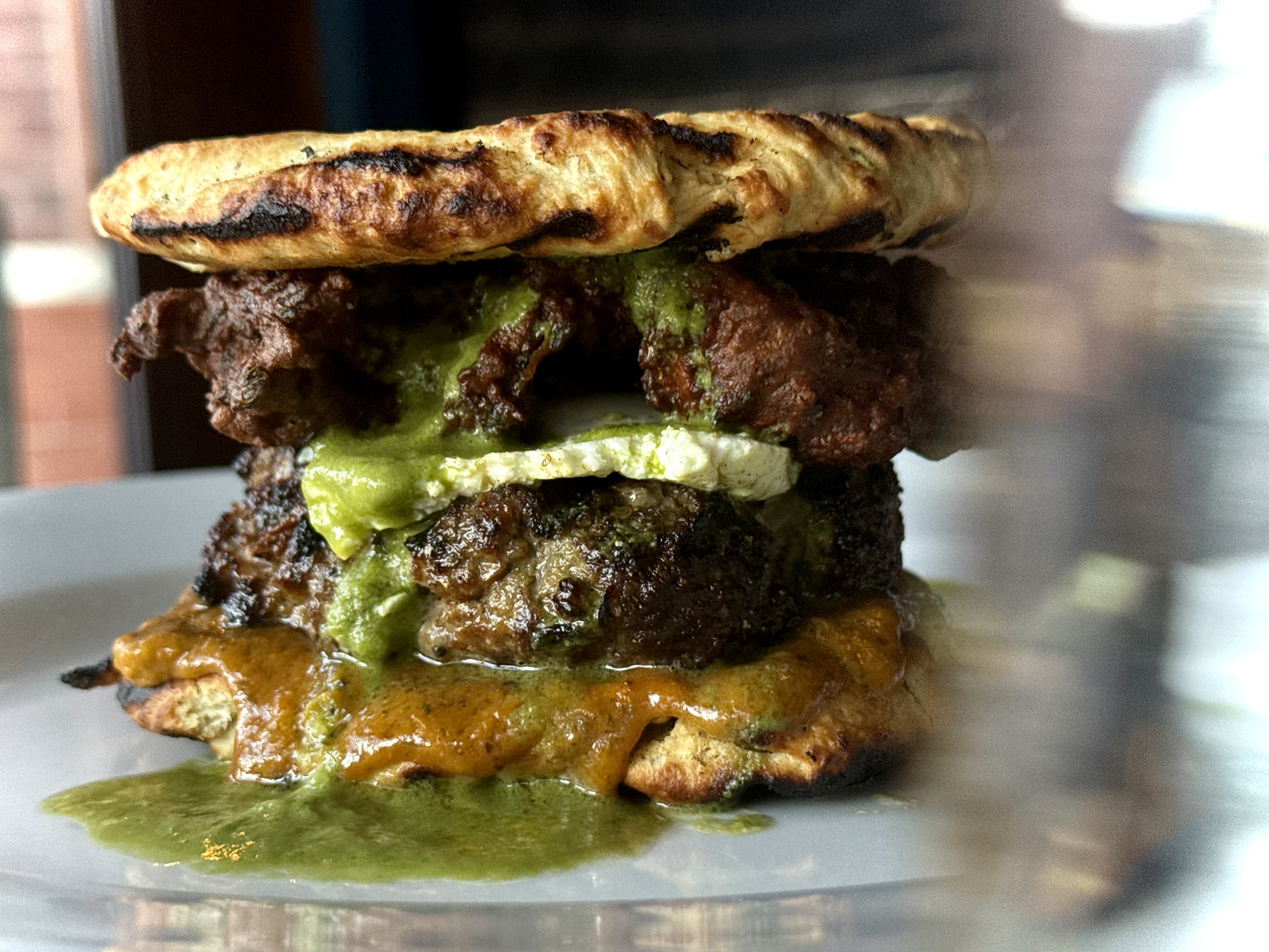 Beef Kofta Burger - Parker's Bistro - Kofta patty, paneer cheese, pakora fritter, garlic bun, green chutney and curry bbq sauce.