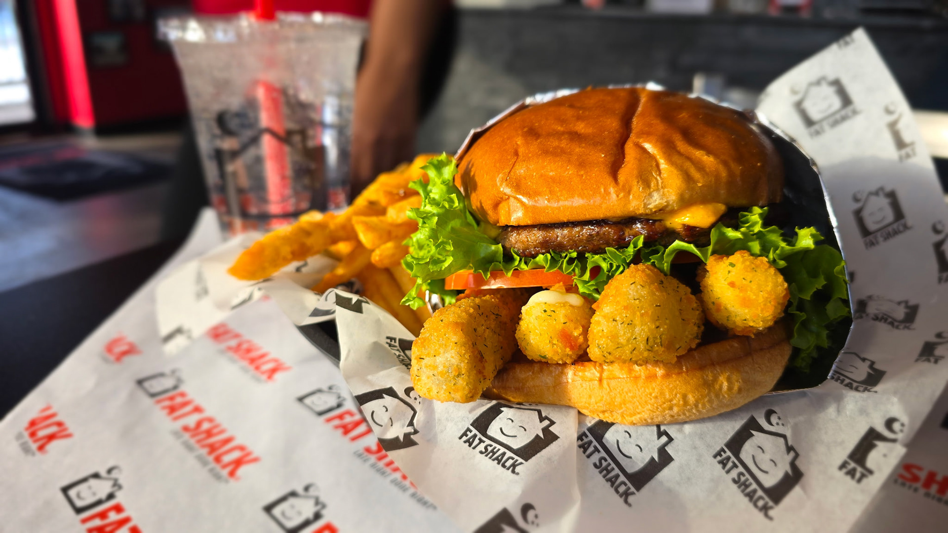 The Fat Clucker - Fat Shack - Fat Shack's signature Angus patty slathered in our garlicky, cracked-pepper Bird Sauce topped with melted American Cheese. Stacked tall with crunchy fried pickles, gooey mozzarella sticks, onion, tomato and lettuce on a brioche bun toasted to perfection. 