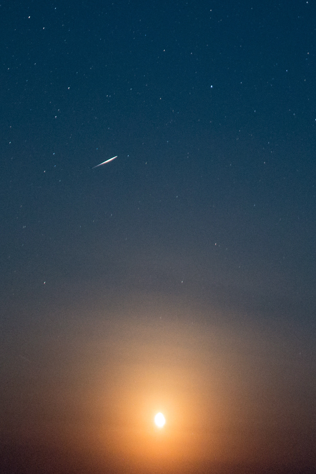 A perseid flares in the atmosphere above the moon. Xrisi Ammoudia, Thasos, Greece.