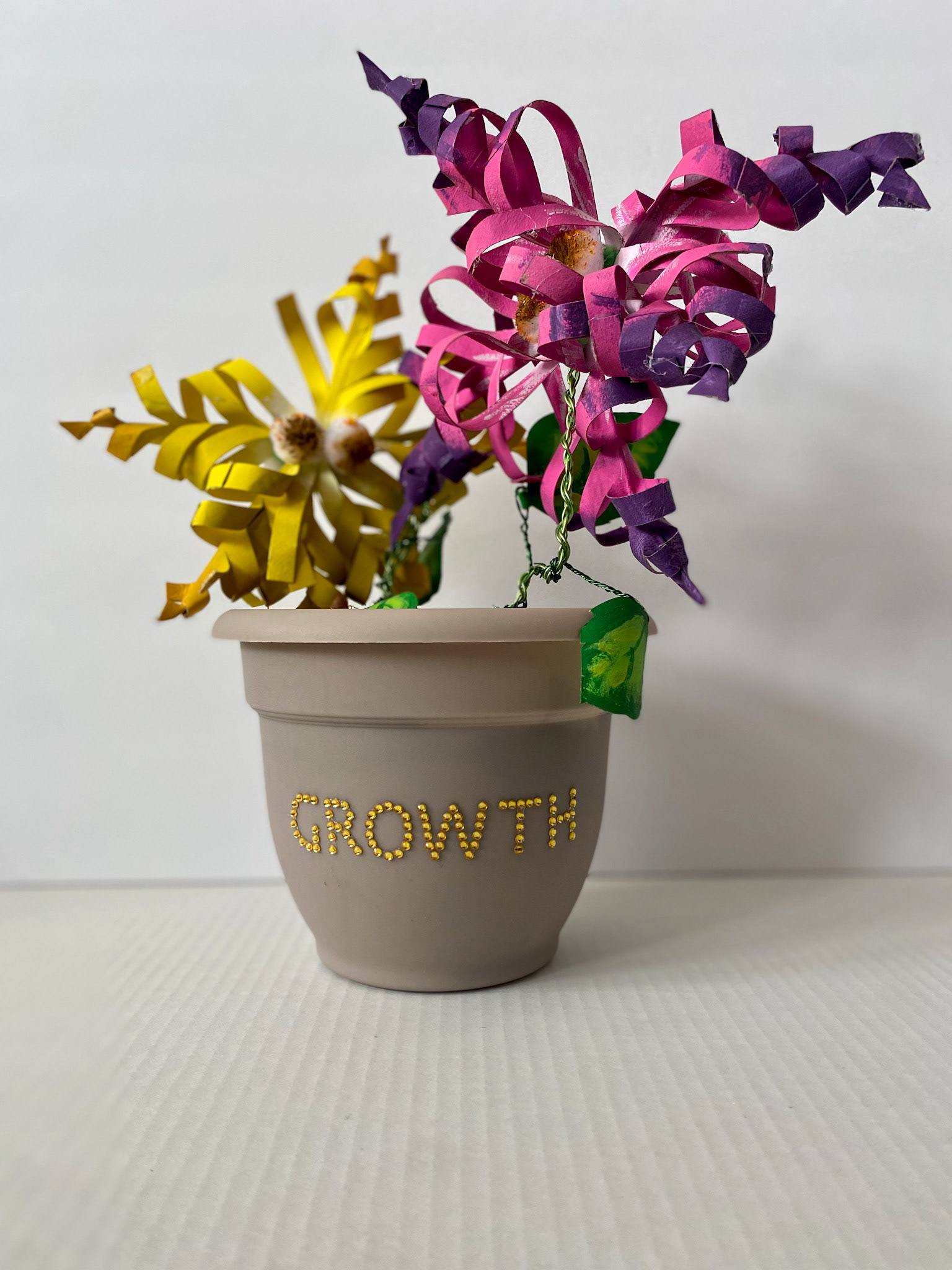 "Growth" 2023. Mixed Materials. Height 14". 3-D  made with found/recycled  materials