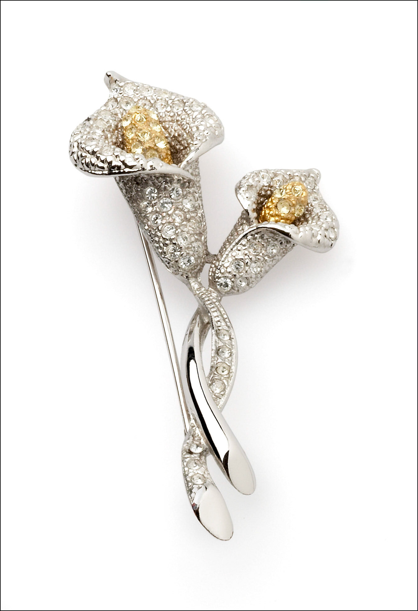Gold and silver broach photographed on white background