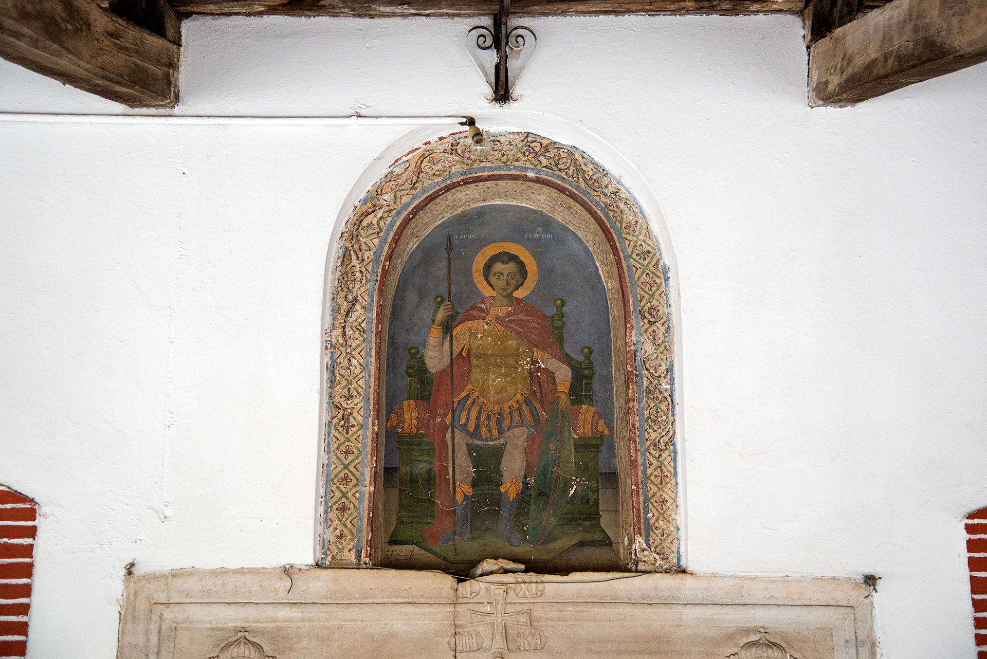 Icon of Saint George seated on a throne above the west entrance