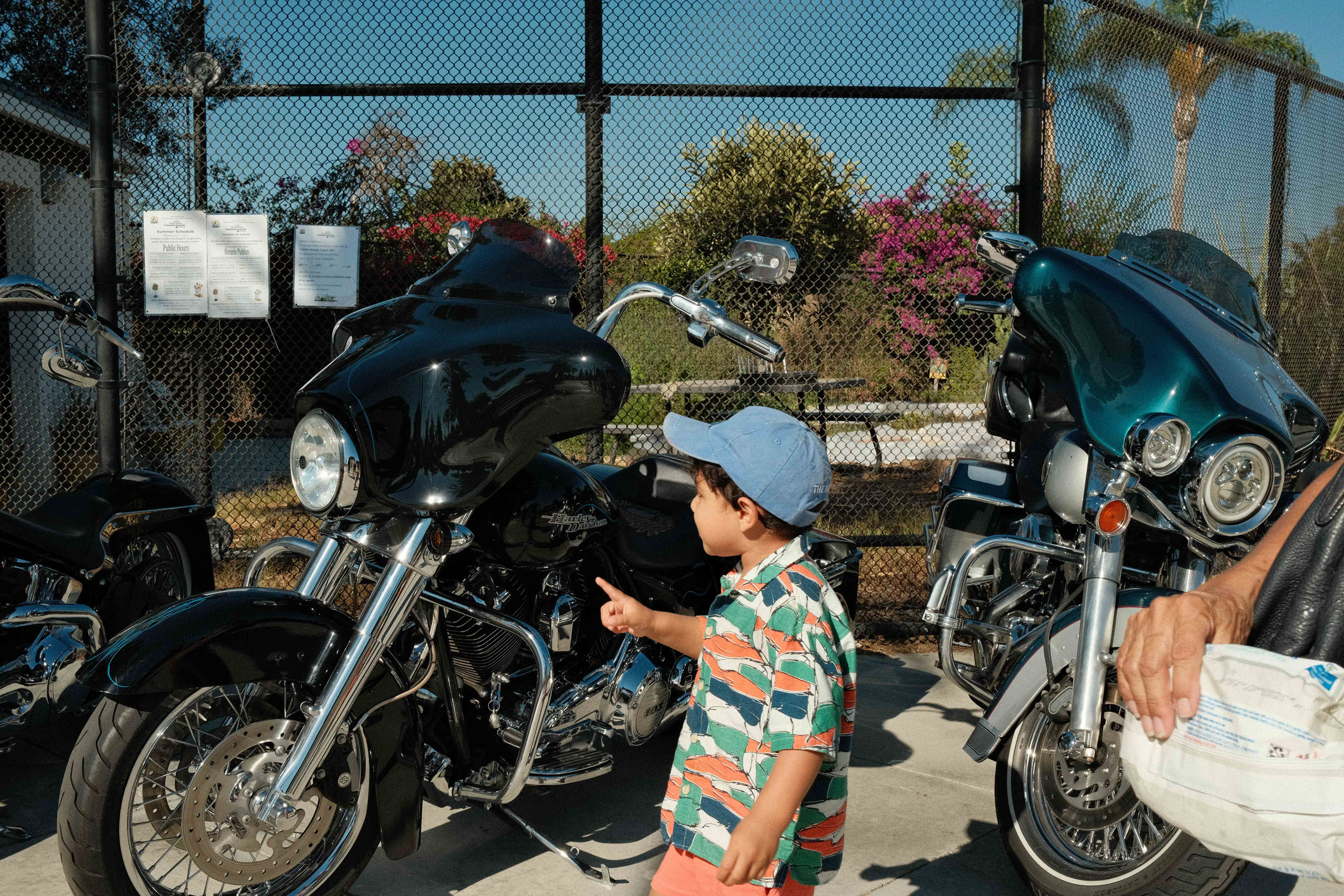 Youth looks at the motorcycles.