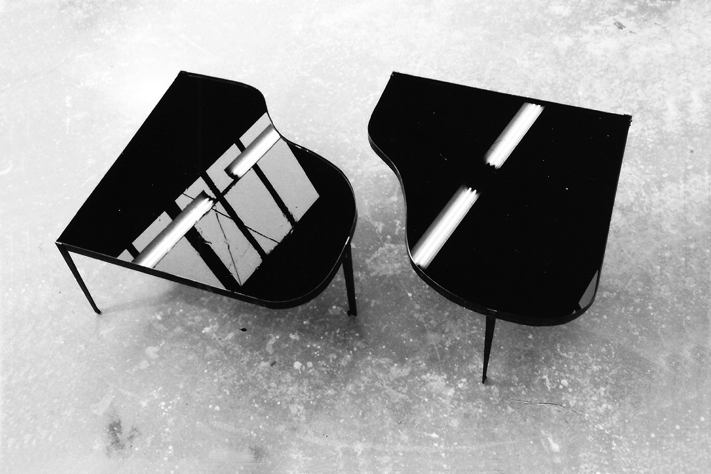 Life size grand pianos filled with oil.