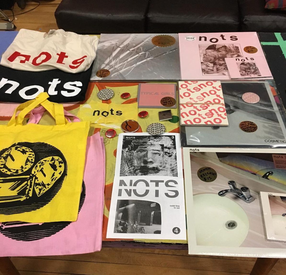 NOTS merch table circa 2017. Hand screen printed Shirts and totes, buttons I designed.