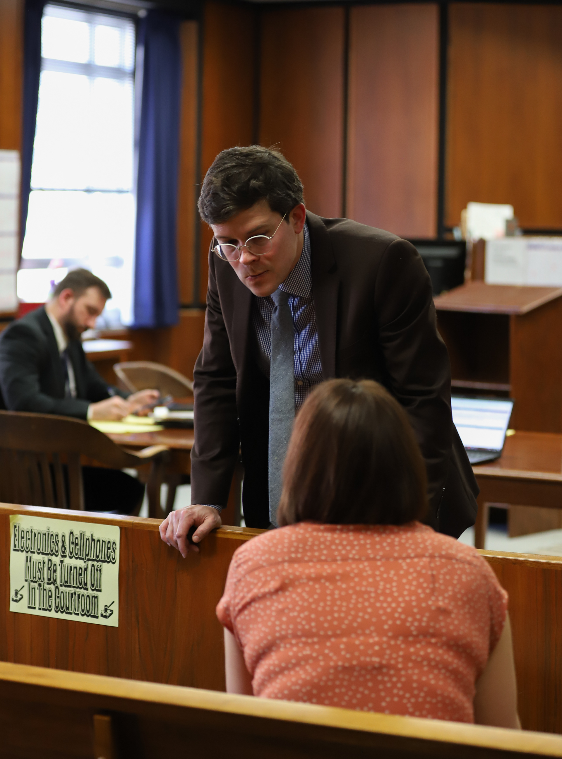 Lewis talks with Ryan Wolfe, a St. Louis trial office public defender, before a hearing in Judge Lynne Perkins’ courtroom on Thursday, Marcah 13, 2025, in St. Louis. Lewis was there for her client’s bond hearing to share updates about the treatment plans she lined up over the past weeks.