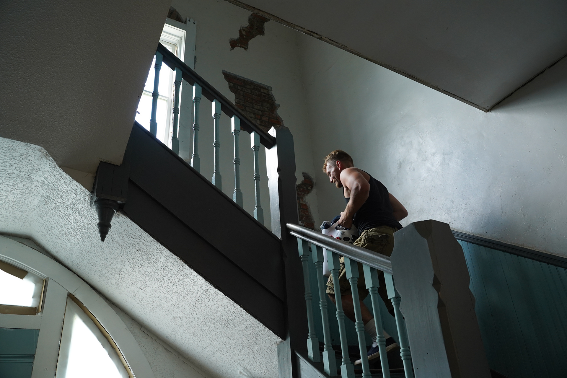 Jacob Adams walks up the stairs of the Whosoever men's recovery house with his laundry in hand on Friday, July 4, 2025, in Stotts City, Mo. Stotts City is a town known for the drug use and trade. Whosoever and other faith-based programs have come into the town to try and reverse the trend, often clashing with locals. 