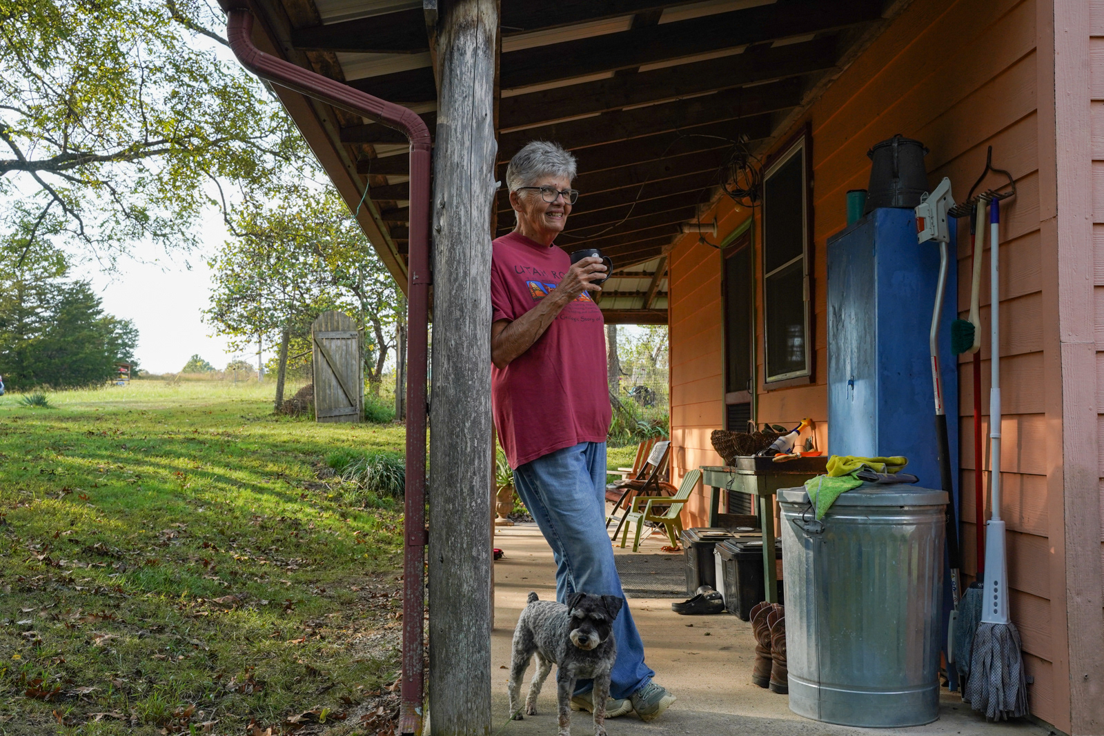 Cindy Perry's parnter Jan smiles on the porch of her home while Cindy gives a tour of their home on the Hawk HIll Community Land Trust. The Ozarkian land is composed of local lesbians who live as a collective, with their own rules and practices for living on the land. 