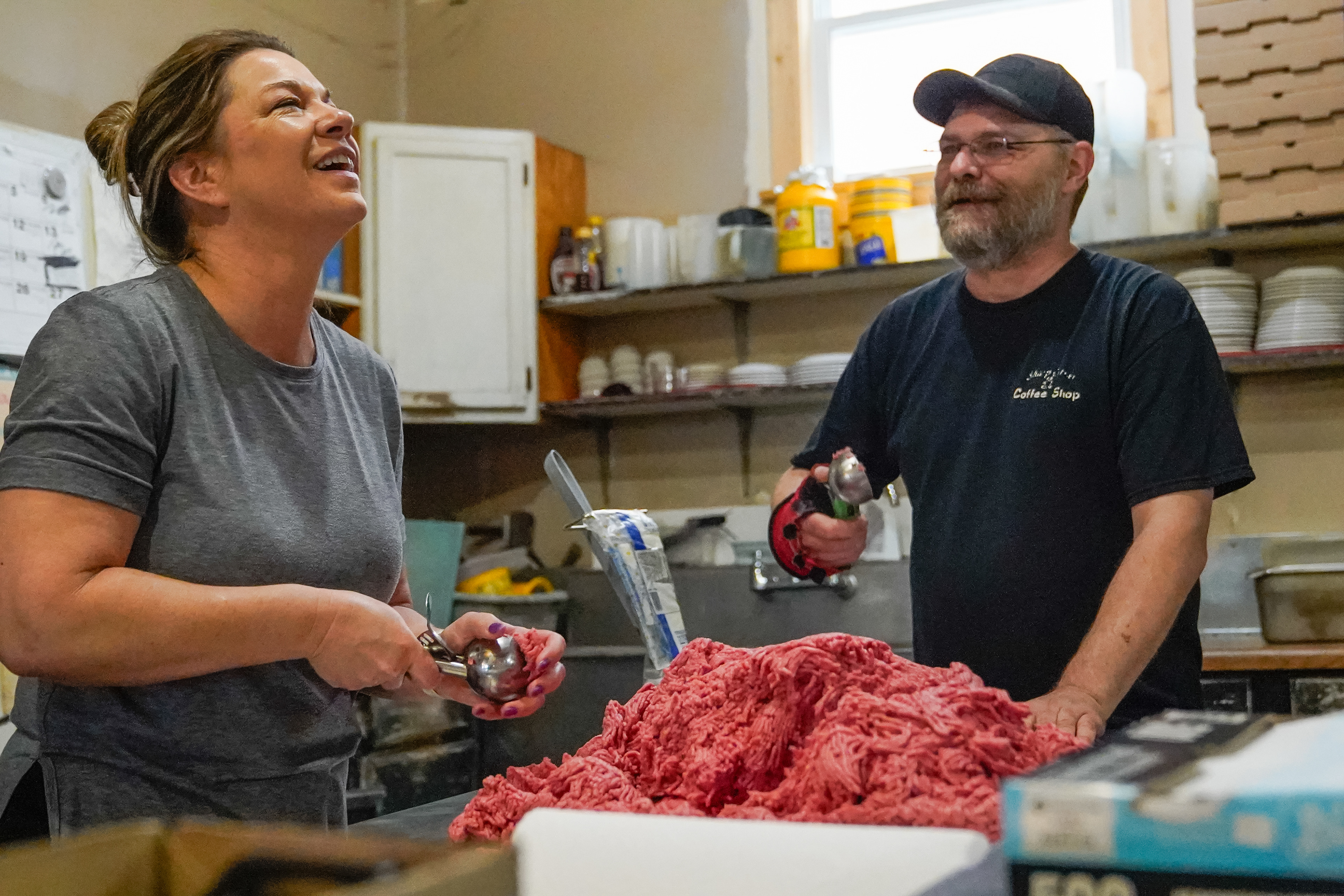 Sharp Corner Tavern co-owners Sarah Hoelmer, left, and Toby Hoelmer prepare burger meat on Monday, April 9, 2024, at the Sharp Corner Tavern in Hermann, Mo. Toby starts preparations for the day before the sun rises, while Sarah comes in around 8 a.m. The burger meat is a unique blend of 71% meat and 29% fat. “It may cost a little more, but it’s better than frozen” Toby said..