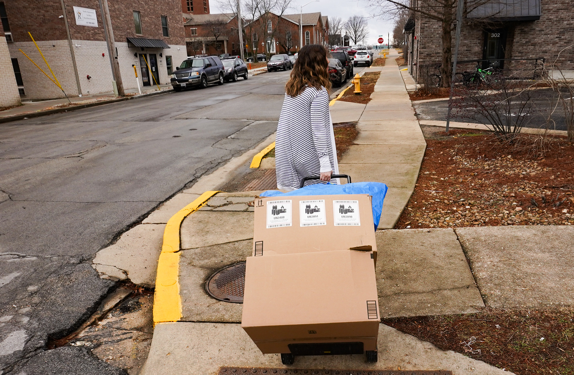 Rowe hauls a box of clothing donations outside of the office on Friday, Jan. 31, 2025, in Rolla, Mo. Rowe’s passion for helping clients extends beyond the office. Four or five times a year, she brings collected donations from her co-workers and gives them to local charaties. At various points throughout the year, her office is filled with clothing, bulk toothbrushes, waterproof warming blankets, homemade birthday boxes for kids, books and puzzles to donate to jails and more.