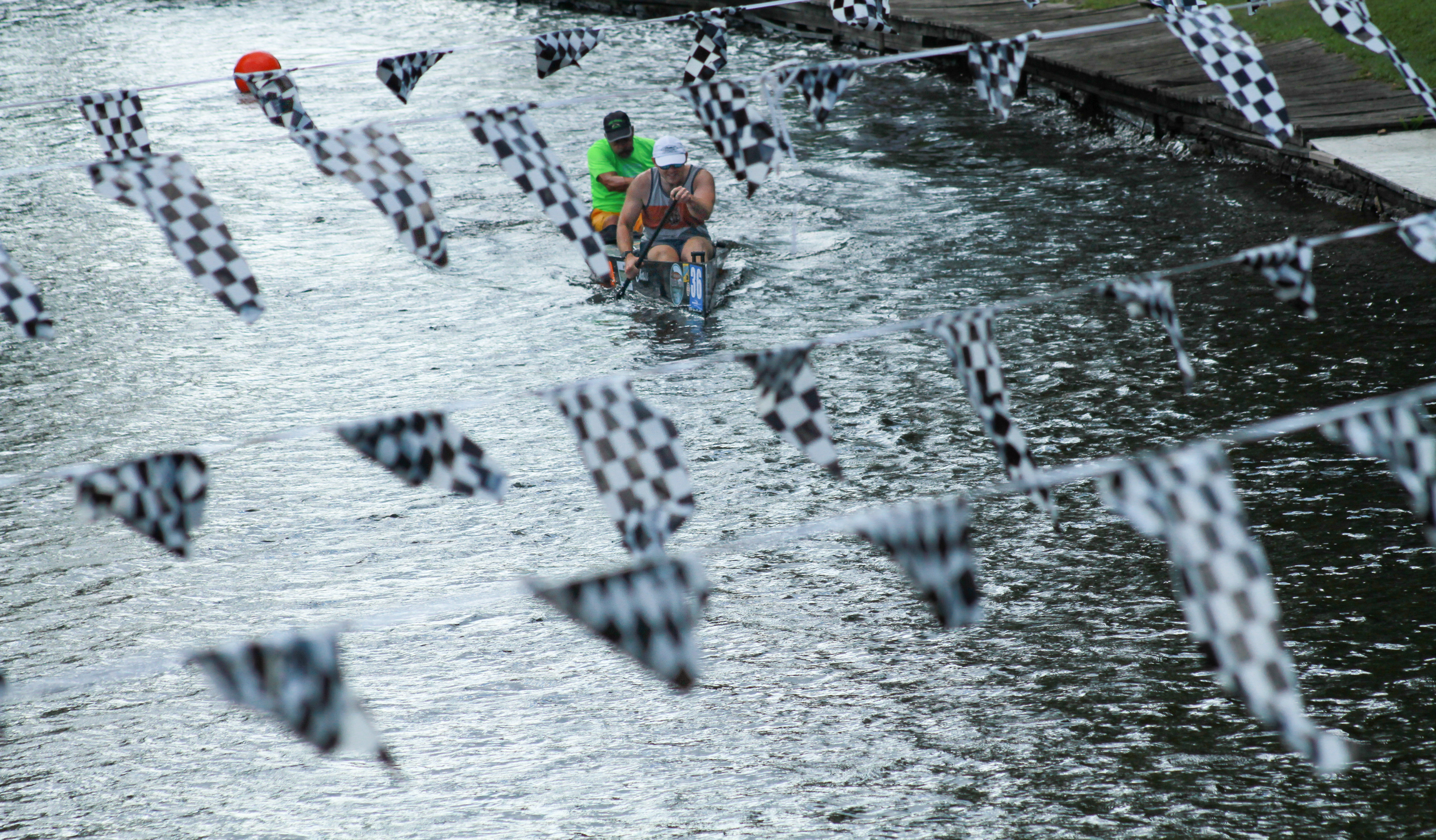 An all-male canoe racing team paddles down the Au Sable River during their time trial for the marathon race on Thursday, July 25, 2024, in Grayling, Mich. The marathon is one of three races part of the "canoe racing triple crown", alongside the General Clinton Canoe Regatta in New York and the La Classique internationale de canots de la Mauricie in Quebec. 