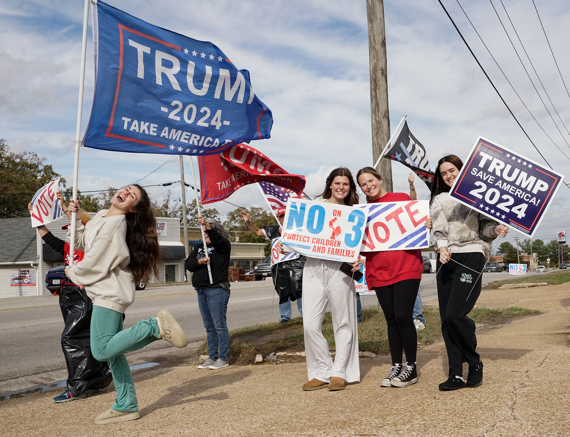 From left, former President Trump supporters Victoria Ellis, Ellie Gattermeir, Mattie Chambers, and Rayden Duncan of the Camden County Republican Club pose for a portrait on Tuesday, Nov. 5, 2024, alongside Highway 54, in Camdenton, Mo. Ellis said that if Trump does not get elected, “things will go higher in prices and not back down how they should be.”
