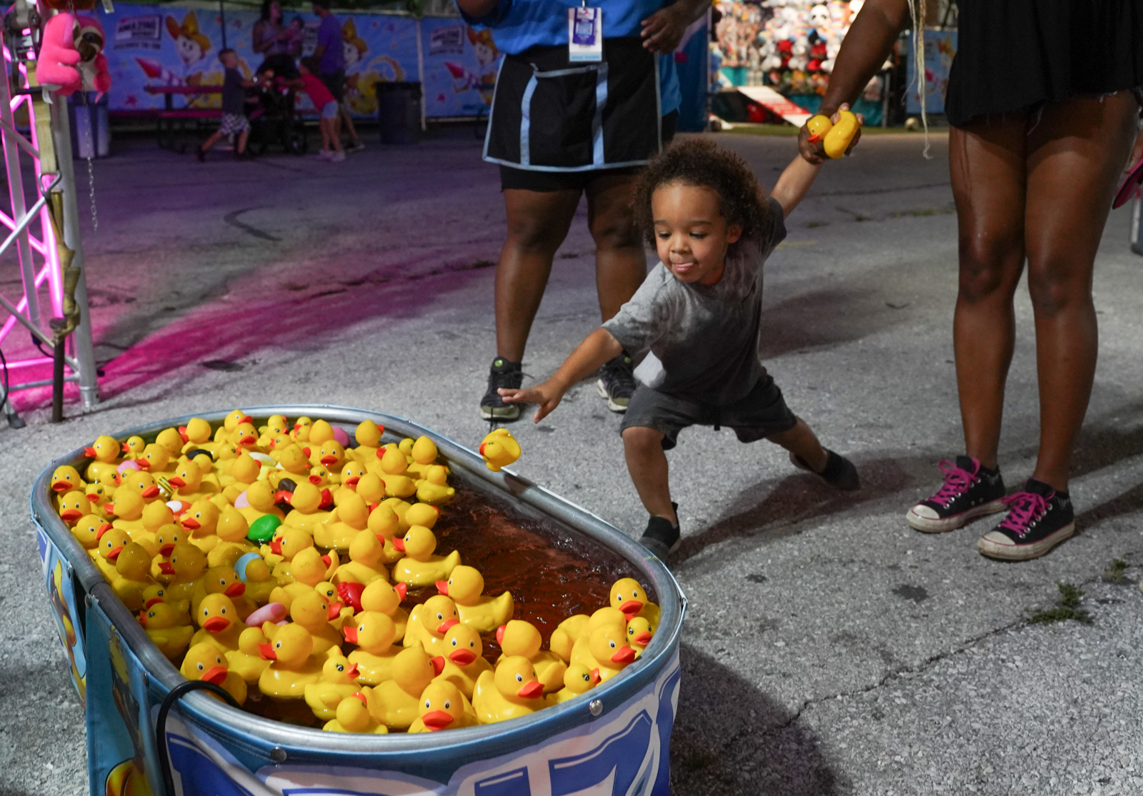 Jason Hill, 3, returns a toy duck to the tub after picking a winner on Friday, July 25, 2025, at the Ozark Empire Fairgrounds in Springfield. Hill ultimately picked out a turtle plush toy while his sister claimed a hot dog. 
