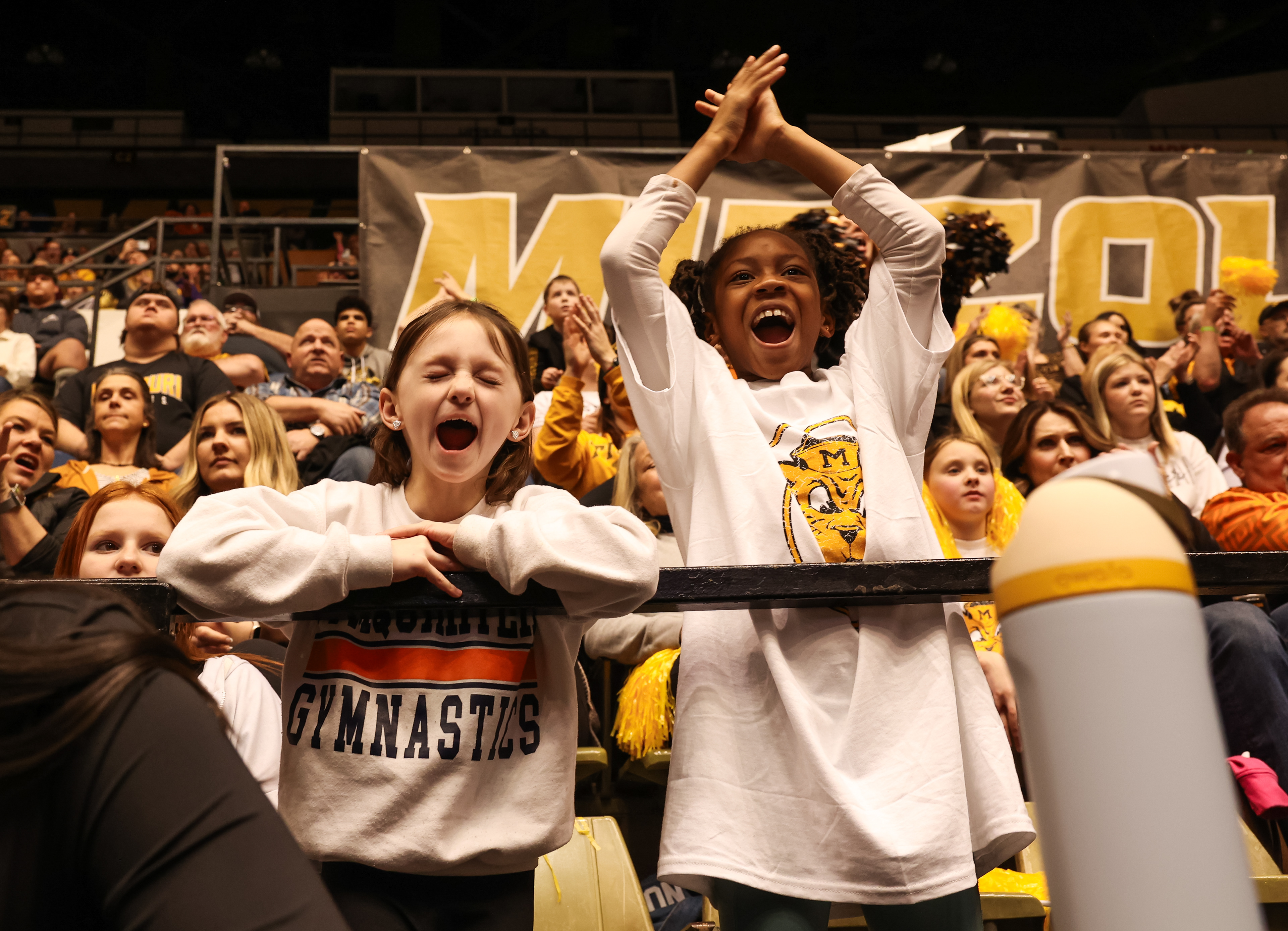 Gabi Frisz, 8, and Trinity Whitney, 9, celebrate after Mizzou gymnastics completes a routine on Friday, Jan. 26, 2024, in Columbia, Mo. The Hearnes Center had a sell out crowd, in part due to the popularity of LSU gymnast, Livvy Dunne.  