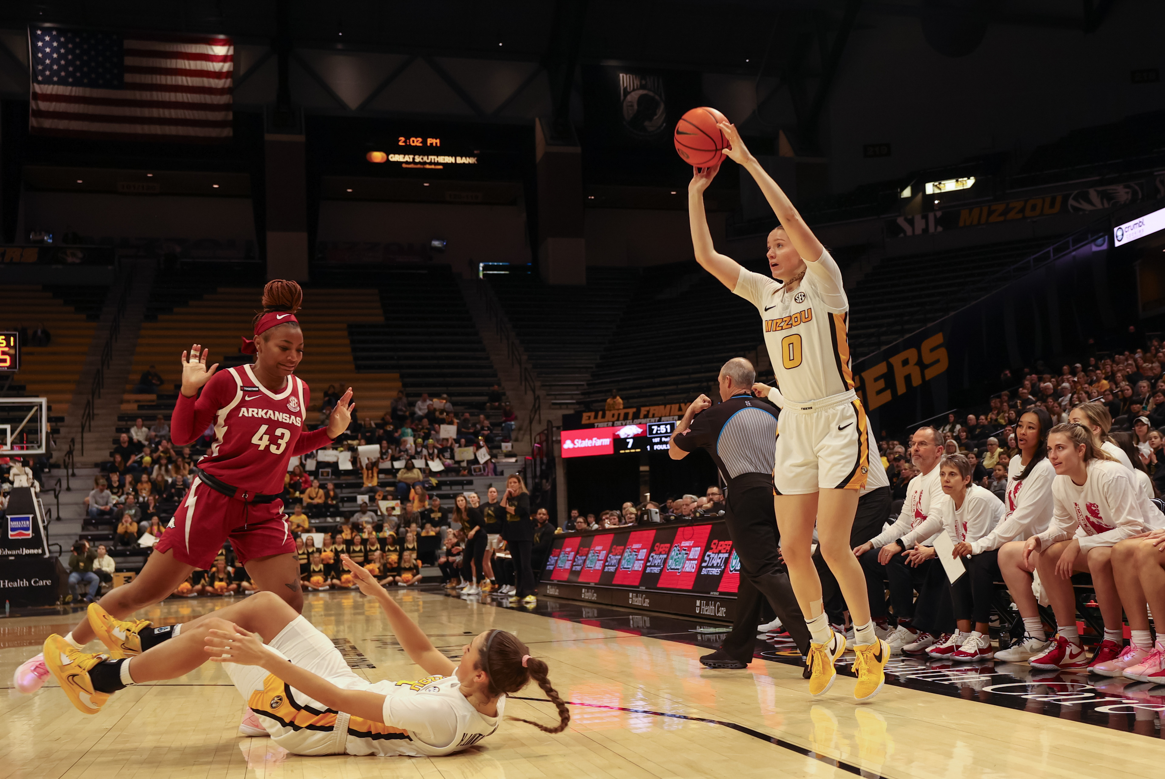 Mizzou guard Grace Slaugher, left, shoots over teammate Hannah Linthacum, ground, and Arkansas guard Makayla Daniels on Sunday, Jan. 28, 2024, in Columbia, Mo. Mizzou lost the game 67-58.  