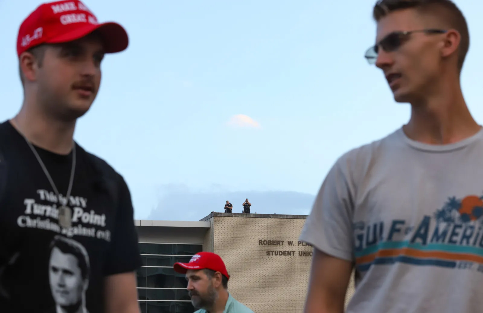 Law enforcement officers are seen surveilling the vigil for Charlie Kirk from the top of the Robert W. Plaster Student Union on Monday, Sept. 22, 2025, in Springfield, MO.