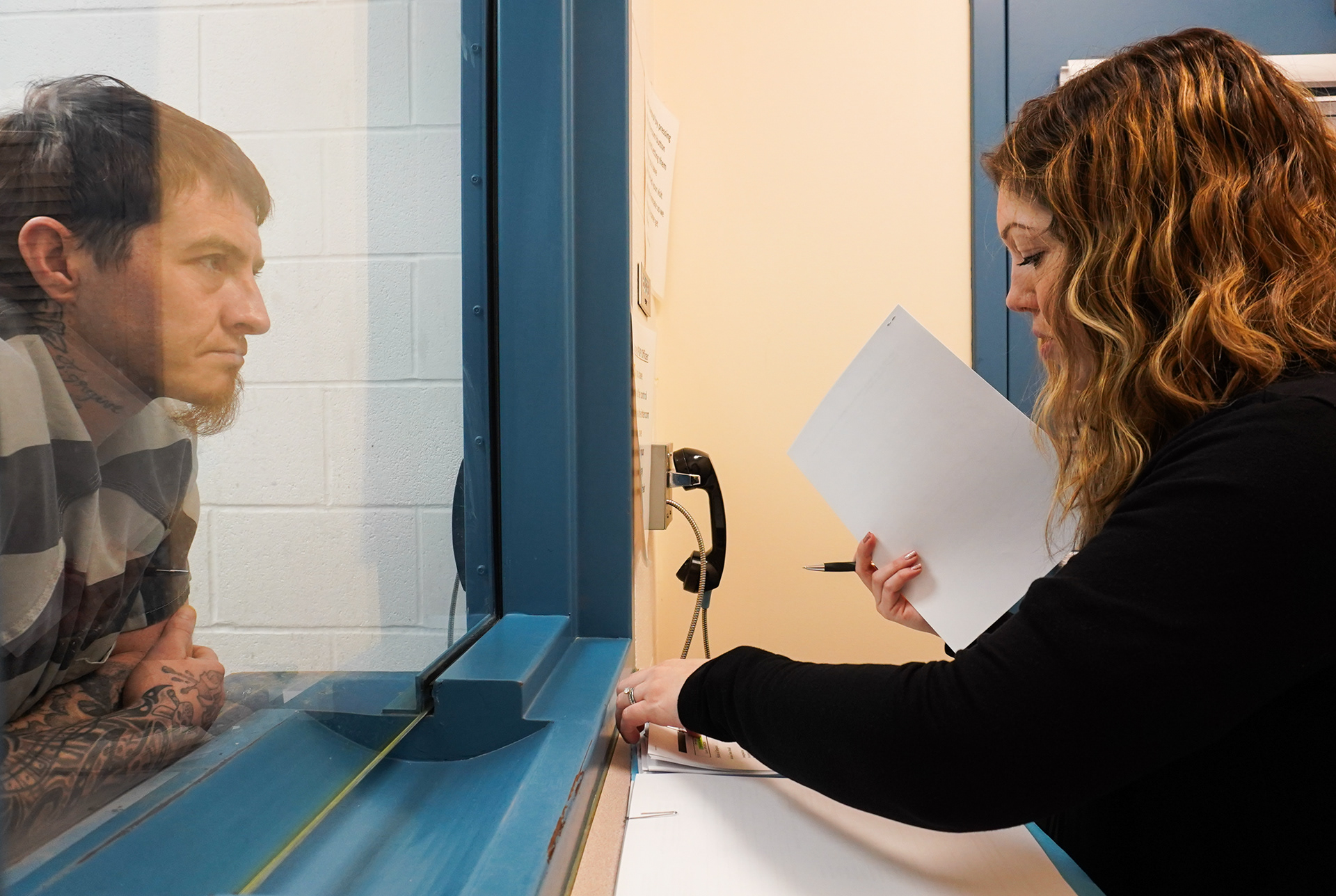 Rowe sits with Josh Johnston on Friday, March 7, 2025, at the Phelps County Jail, in Rolla, Mo. The most common service that Rowe helps clients enter is addiction treatment. In rural Missouri, that can be community health programs like CORE (communities of recovery experience) or religious organizations like Mission Gate. Through the HDS grant funding, Rowe helps coordinate the use of HDS funds to ensure that application fees are paid on behalf of clients. One client’s situation warranted Rowe calling all the local churches to collection donation money to help pay a program fee. “I’ve been told I am anything if not persistent. I take that as a compliment.”