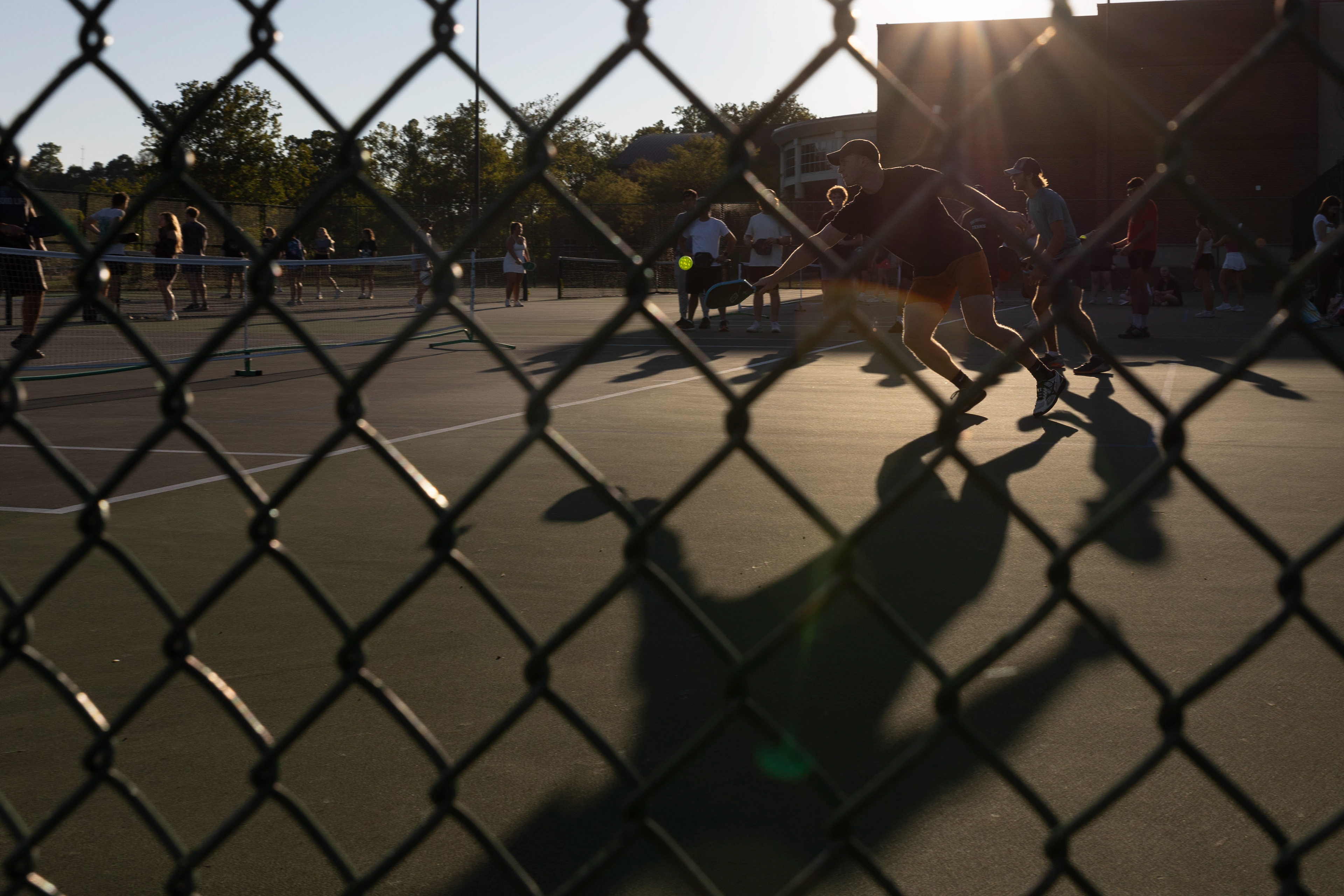 Tyler Douthwaite swings to hit the pickleball during the practice matches for the Pickleball Club at the outdoor courts beside the Golf and Tennis Center, Ohio University, Athens, Sep. 11, 2024