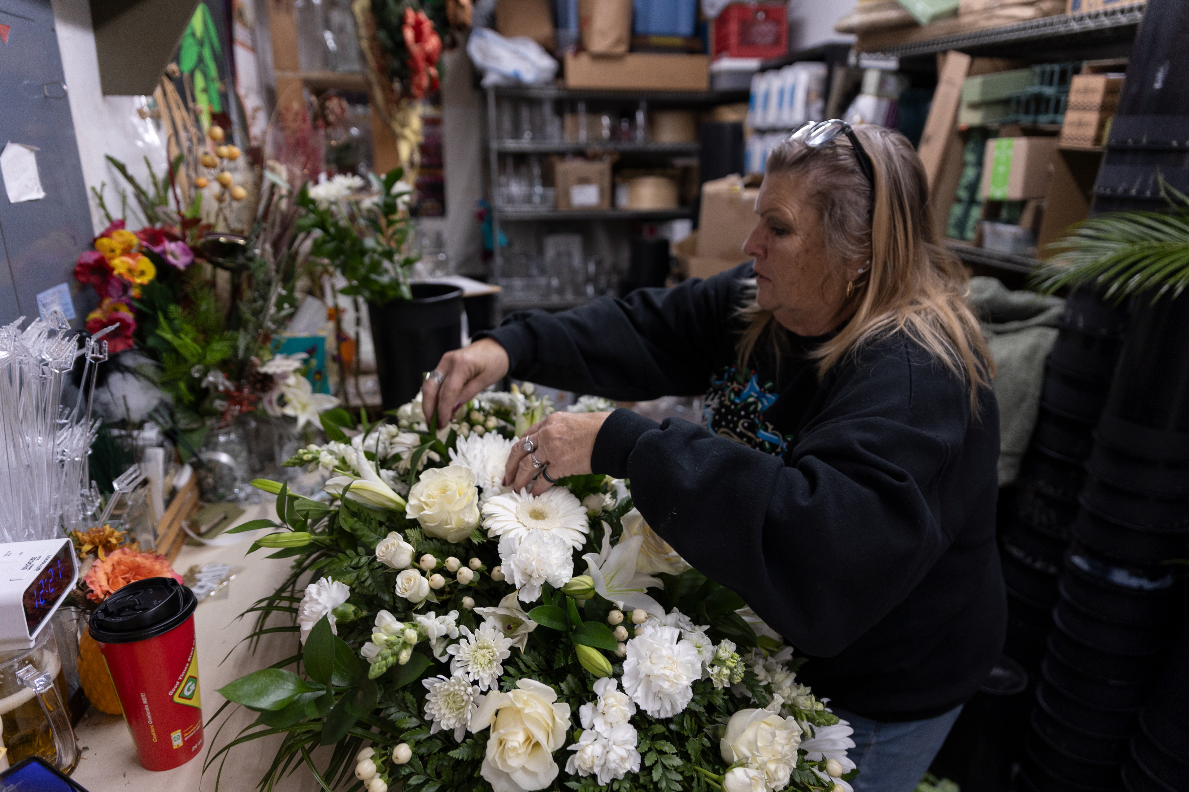 Robin Wagoner puts the finishing touches on a casket spray that would be delivered to Hughes Funeral Home later that afternoon. Robin has worked as a florist for 47 years but has only worked here for three. "When the last flower shop closed down, I came here," Robin said.