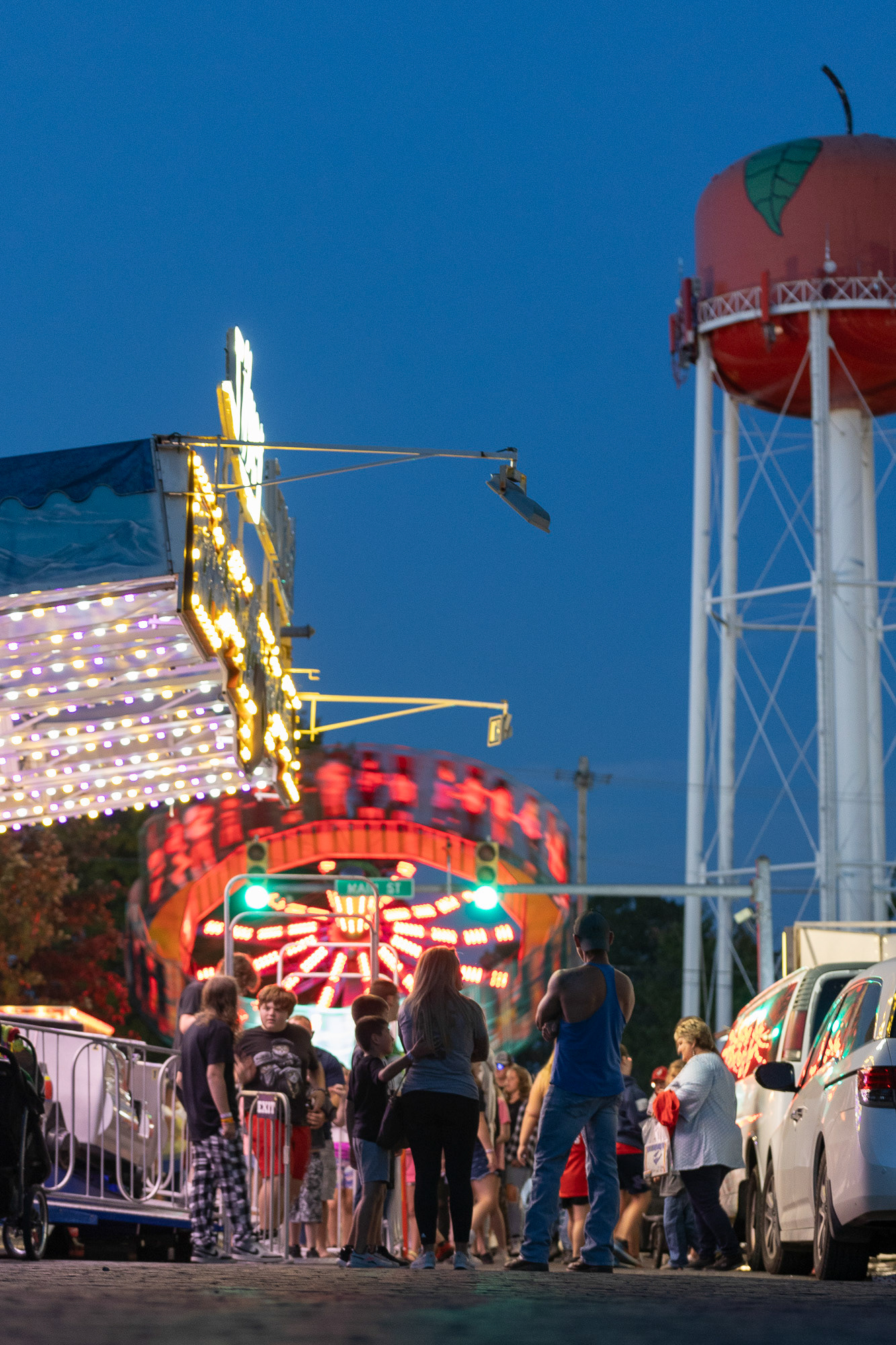 A group of people stand and talk on Main Street during the Jackson County Apple Festival in Jackson, Ohio, Sept. 22, 2023.