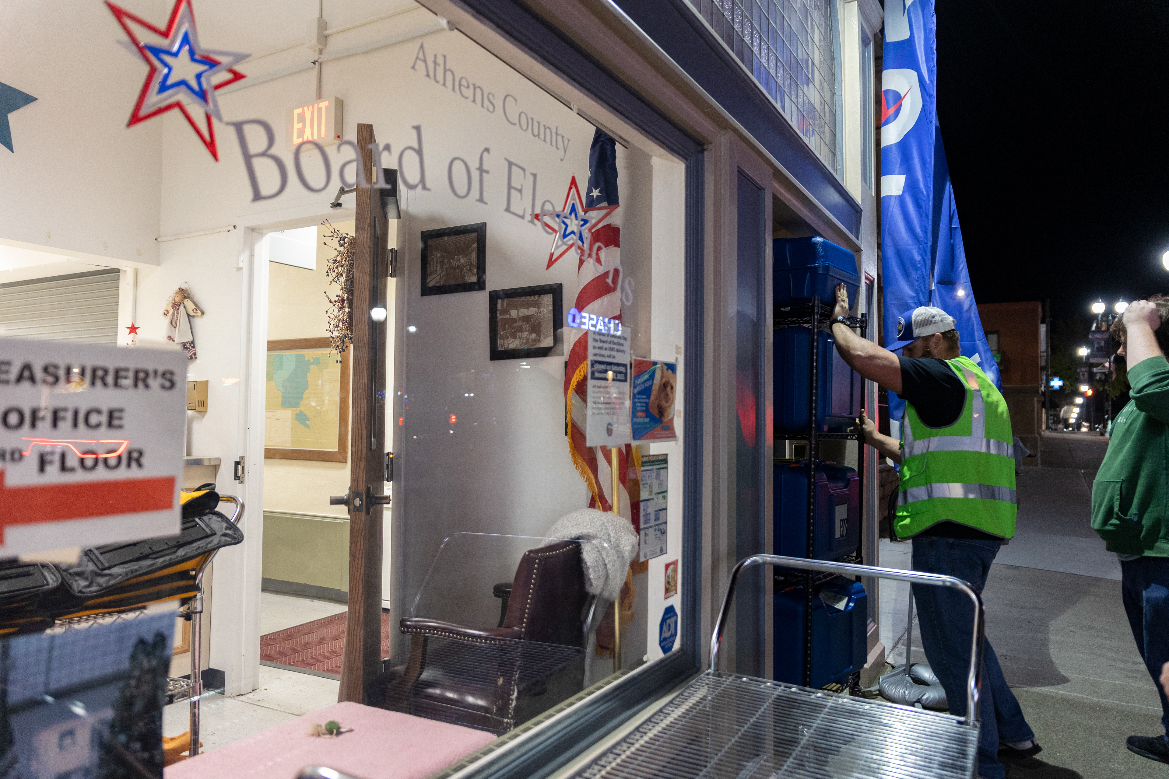A poll worker rolls a cart full of ballots into the Athens County Board of Elections office Nov. 7, 2023.