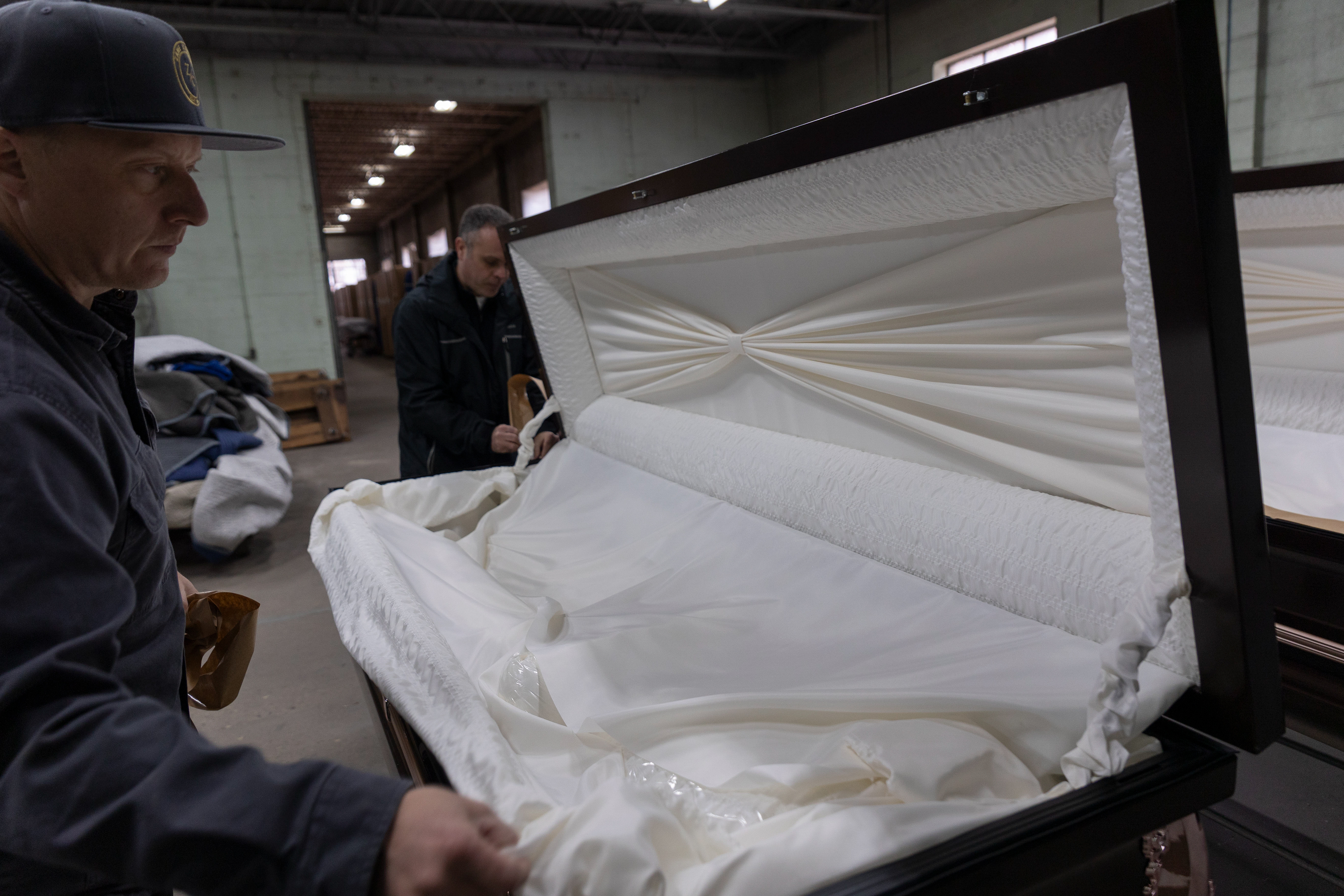 Daniel "Dan" Dougherty and Ross Pattinson check over the insides of caskets that will be shipped out to a funeral home later that afternoon. "I want to provide a good service every time," Dan said, "Our customers are important to us."