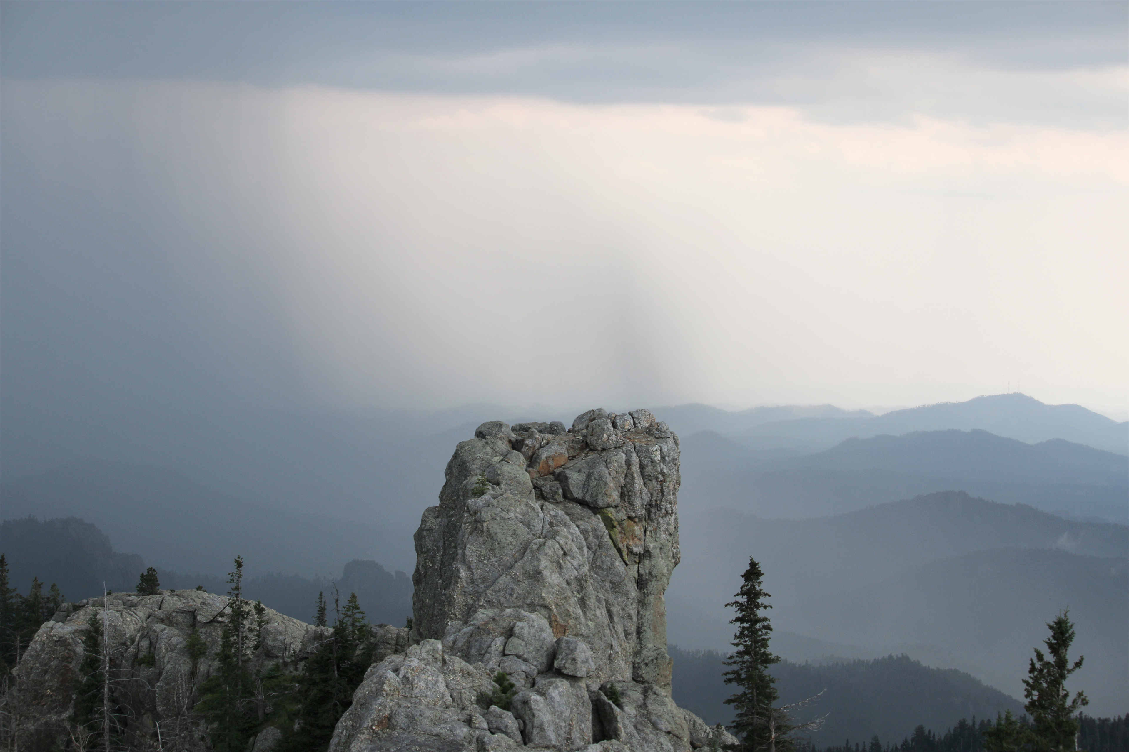 A rain storm blows over Harney Peak in South Dakota July 21, 2021. Harney Peak is the highest natural point in South Dakota.  